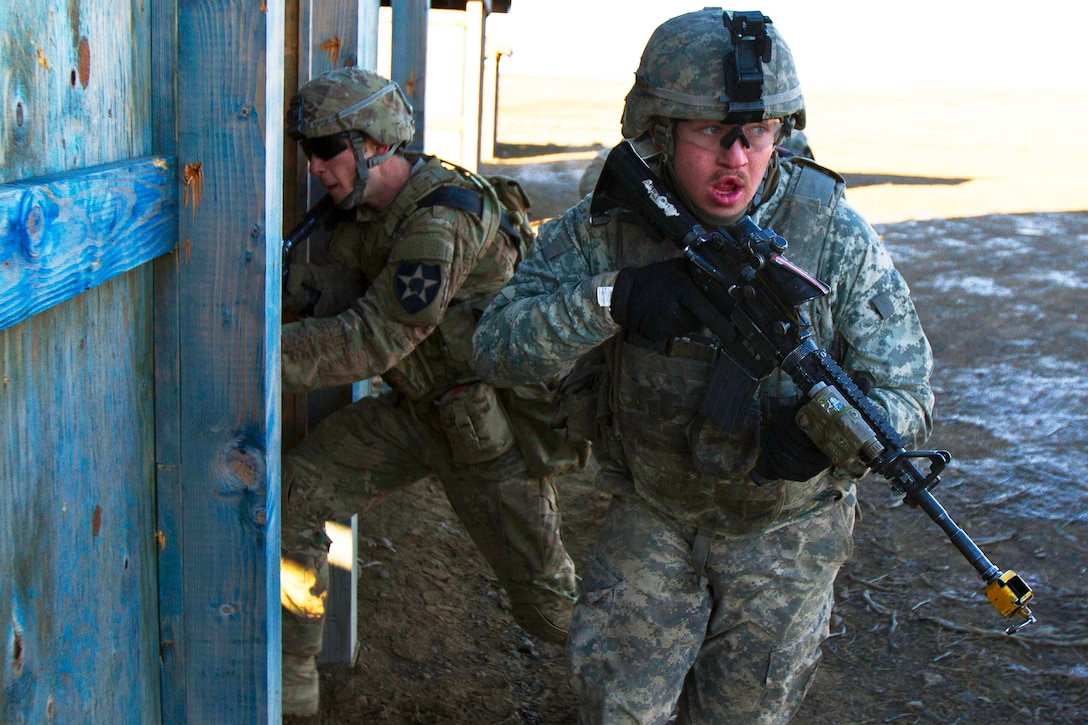 Soldiers breach and clear a shack during urban mount training on Yakima Training Center, Yakima, Wash., Feb. 23, 2016. Bravo Company soldiers performed a combination of mounted and dismounted movements to accomplish their mission. Soldiers assigned to Bravo Company is part of the 5th Battalion, 20th Infantry Regiment, 1-2 Stryker Brigade Combat Team, 7th Infantry Division, Joint Base Lewis-McChord, Wash. U.S. Army photo by Sgt. Cody Quinn