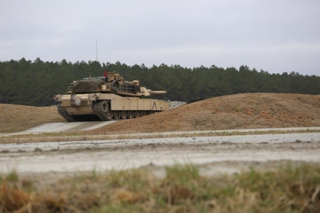 Marines with 2nd Tank Battalion conducted a live-fire exercise at a platoon gunnery tank range for qualification at Camp Lejeune, N.C., Feb. 23, 2016. 2nd Tanks provided direct fire at various targets along the range while moving up and over the berms to improve their reaction times while firing with their M1A1 Abrams tanks. The gunnery range was part of a weeklong, large-scale operation known as Iron Blitz. Iron Blitz, a Marine Corps Combat Readiness Evaluation, tested 2nd Tanks in their ability to integrate all aspects of the Marine Air-Ground Task Force and function as a deployment-ready unit. (Marine Corps photo by Cpl. Shannon Kroening)