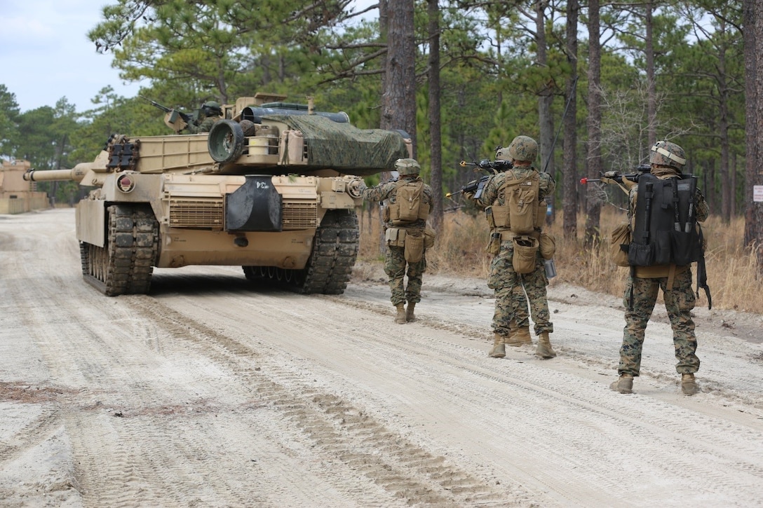 Marines with 2nd Tank Battalion along with 3rd Battalion, 6th Marine Regiment conducted a raid on Combat Town at Camp Lejeune, N.C., Feb. 21, 2016. 2nd Tanks provided direct fire support while the Marines from 3/6 assaulted the town after receiving word that the town held opposition forces within. The raid was part of a weeklong, large-scale operation known as Iron Blitz. Iron Blitz, a Marine Corps Combat Readiness Evaluation, tested 2nd Tanks in their ability to integrate all aspects of the Marine Air-Ground Task Force and function as a deployment-ready unit. (Marine Corps photo by Cpl. Shannon Kroening)