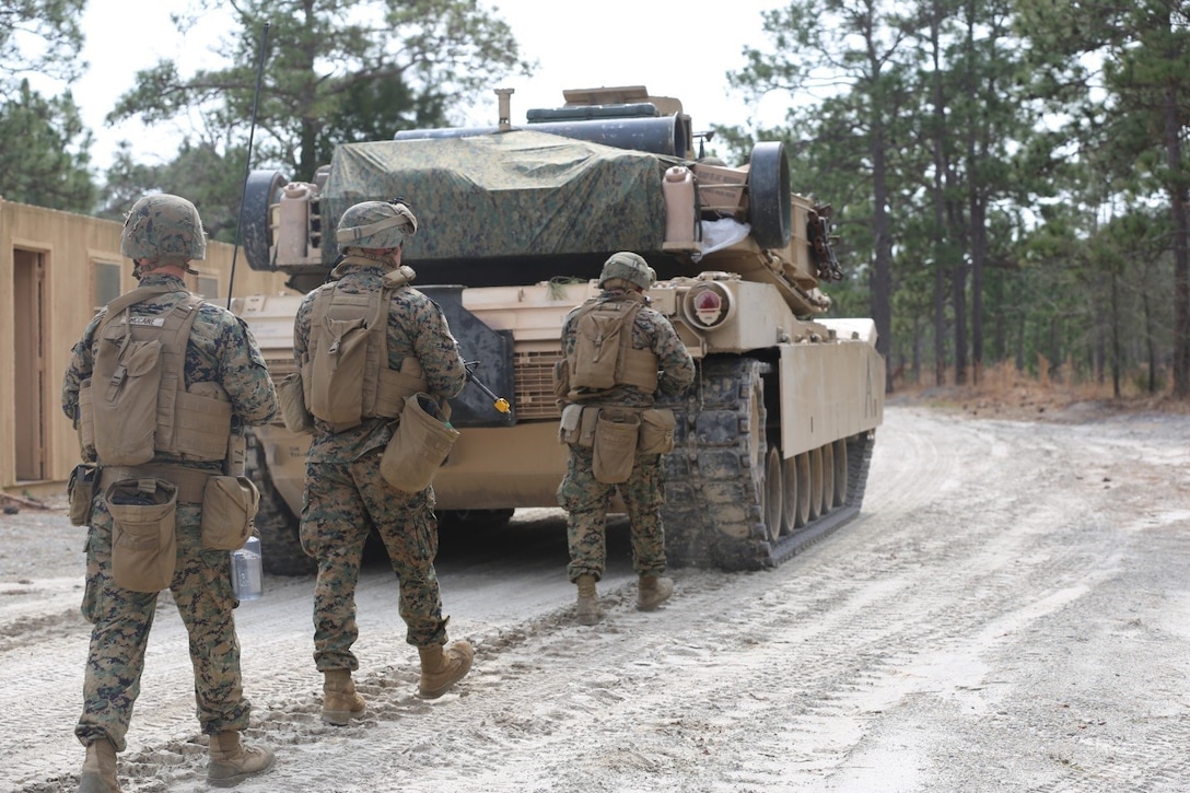 Marines with 2nd Tank Battalion along with 3rd Battalion, 6th Marine Regiment conducted a raid on Combat Town at Camp Lejeune, N.C., Feb. 21, 2016. 2nd Tanks provided direct fire support while the Marines from 3/6 assaulted the town after receiving word that the town held opposition forces within. The raid was part of a weeklong, large-scale operation known as Iron Blitz. Iron Blitz, a Marine Corps Combat Readiness Evaluation, tested 2nd Tanks in their ability to integrate all aspects of the Marine Air-Ground Task Force and function as a deployment-ready unit. (Marine Corps photo by Cpl. Shannon Kroening)