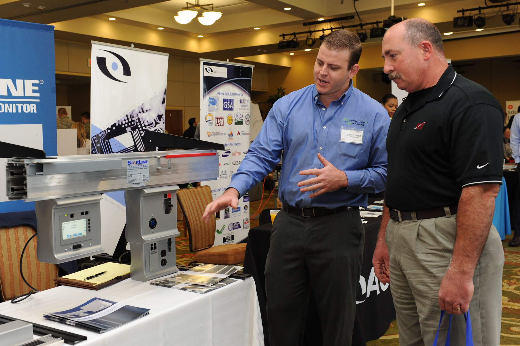 Craig Lougue gives an equipment brief on power monitoring to Arlen Fountain, 81st Medical Group system administrator, during the 21st annual Technology Expo at the Bay Breeze Event Center Feb. 23, 2016, Keesler Air Force Base, Miss. The 81st Communications Squadron hosted the event and attendance was free to all Defense Department, government and contractor personnel with base access. (U.S. Air Force photo by Kemberly Groue)