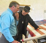 U.S. Army veteran and artist Marcos Antonio (right) explains the meaning behind the Flag for Hope to Fort Sam Houston Museum curator William Manchester (left).