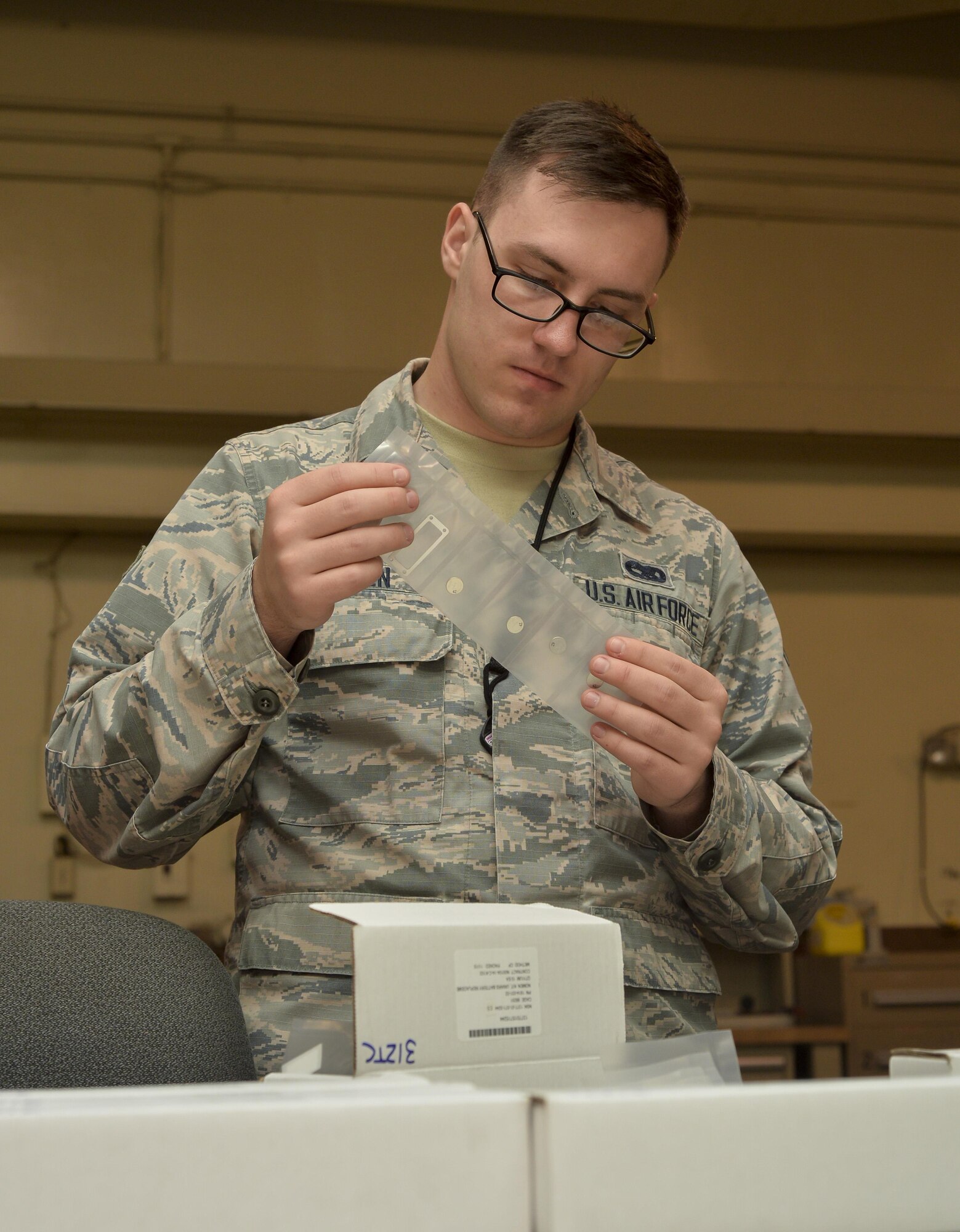 Airman 1st Class Clayton Gowen, 2nd Munitions Squadron munitions inspector, inspects a life support vest battery at Barksdale Air Force Base, La., Feb. 23, 2016. Gowen performed a pre-issue inspection to verify all supplies where present. (U.S. Air Force photo/Airman 1st Class Mozer O. Da Cunha)