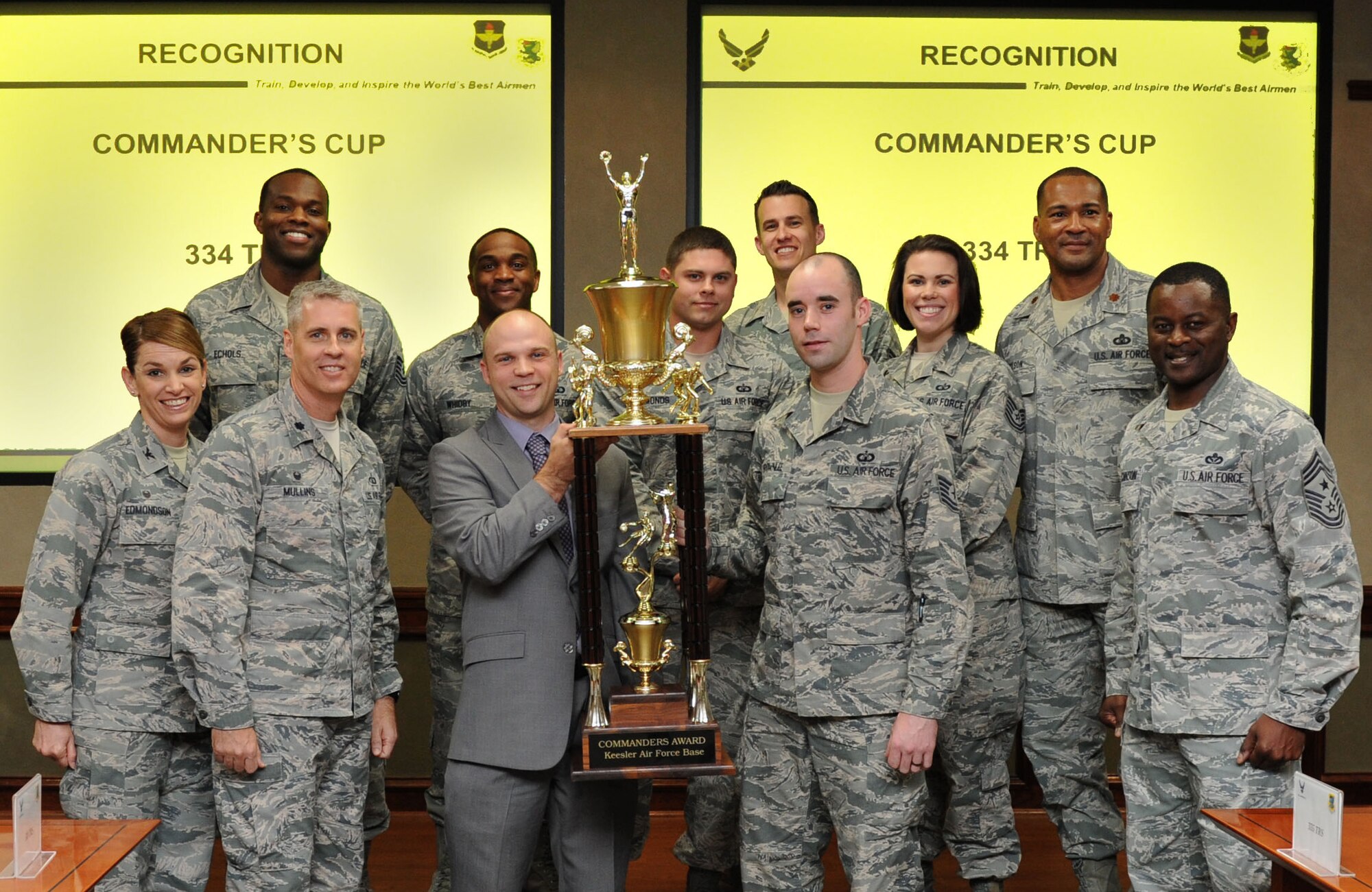 Jake Regal, Keesler sports director, presents the commander’s trophy to the 334th Training Squadron at Stennis Hall Feb. 24, 2016, Keesler Air Force Base, Miss. The competition is centered around points awarded to a squadron based on their participation in the intramural sports program and special events facilitated by the base fitness centers. This is the 6th consecutive year the “Gators” have earned the trophy. (U.S. Air Force photo by Kemberly Groue)