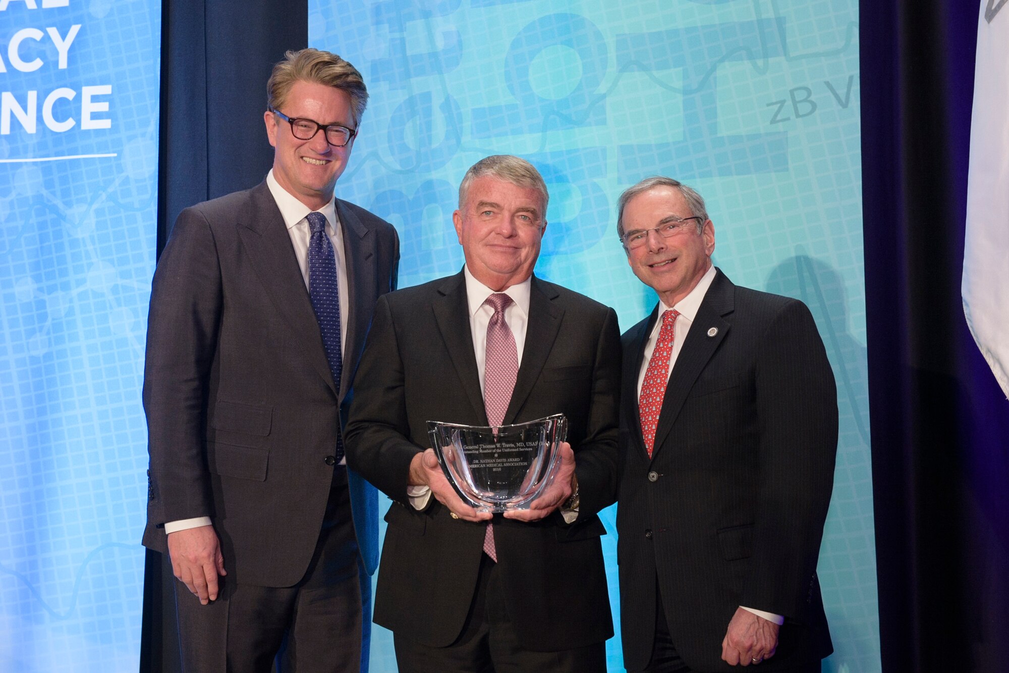 Lt. Gen. (Ret.) Thomas Travis, Air Force Surgeon General, was presented with the American Medical Association’s Dr. Nathan Davis Award for Outstanding Government Service, for his outstanding contributions to the betterment of medicine and public health. Travis (center) is pictured with Joe Scarborough (left), MSNBC’s Morning Joe co-host and Stephen Permut (right), Chair, AMA Board of Trustees. (Courtesy Photo)