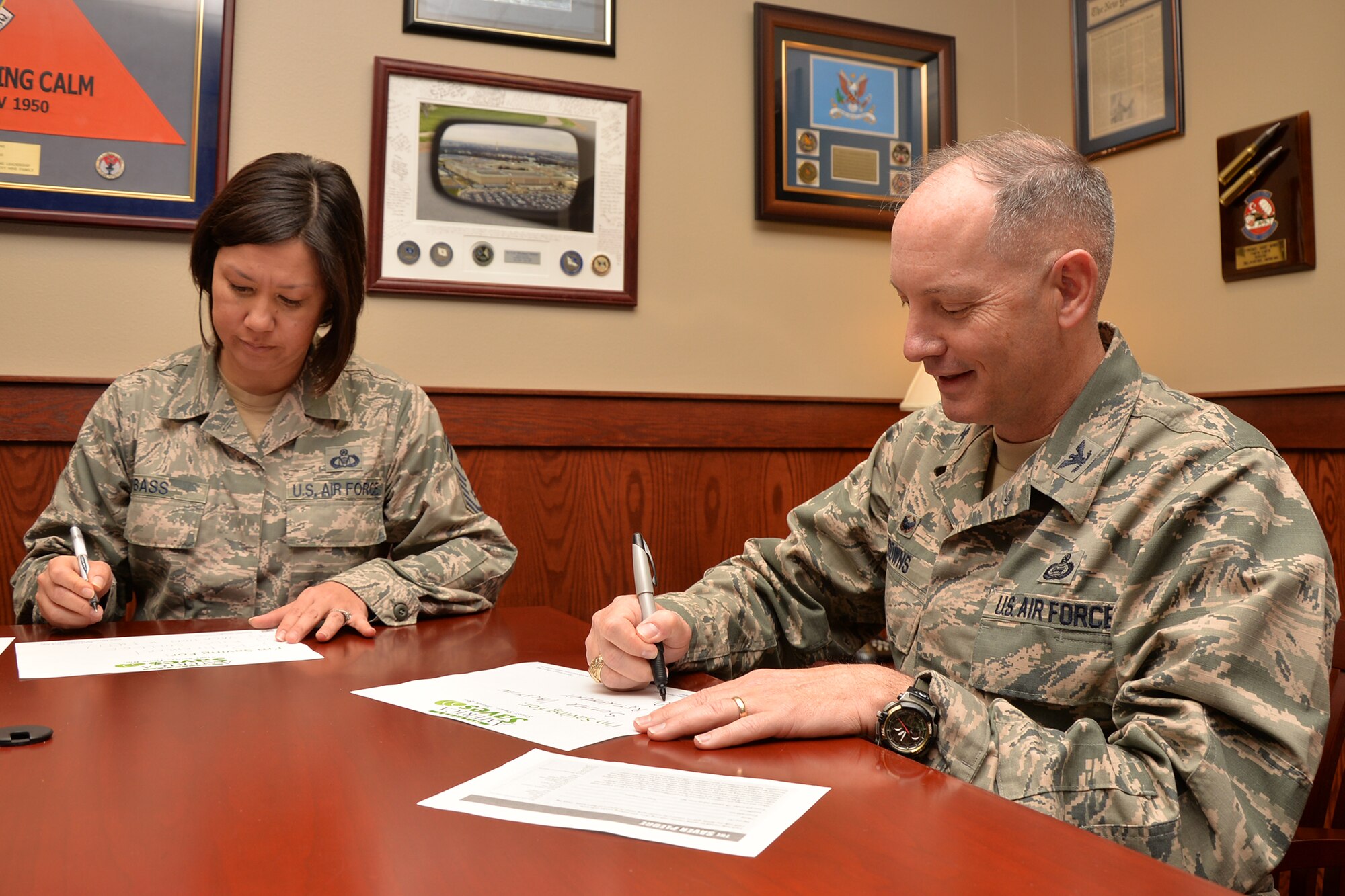 U.S. Air Force Chief Master Sgt. JoAnne S. Bass, 17th Training Wing Command Chief, and Col. Michael L. Downs, 17th Training Wing Commander, make pledges to save money as part of the Military Saves Campaign on Goodfellow Air Force Base, Texas, Feb. 22, 2016. Downs pledged to save for a summer vacation, retirement and Dallas Cowboys tickets. (U.S. Air Force photo by Airman 1st Class Randall A. S. Moose/Released)