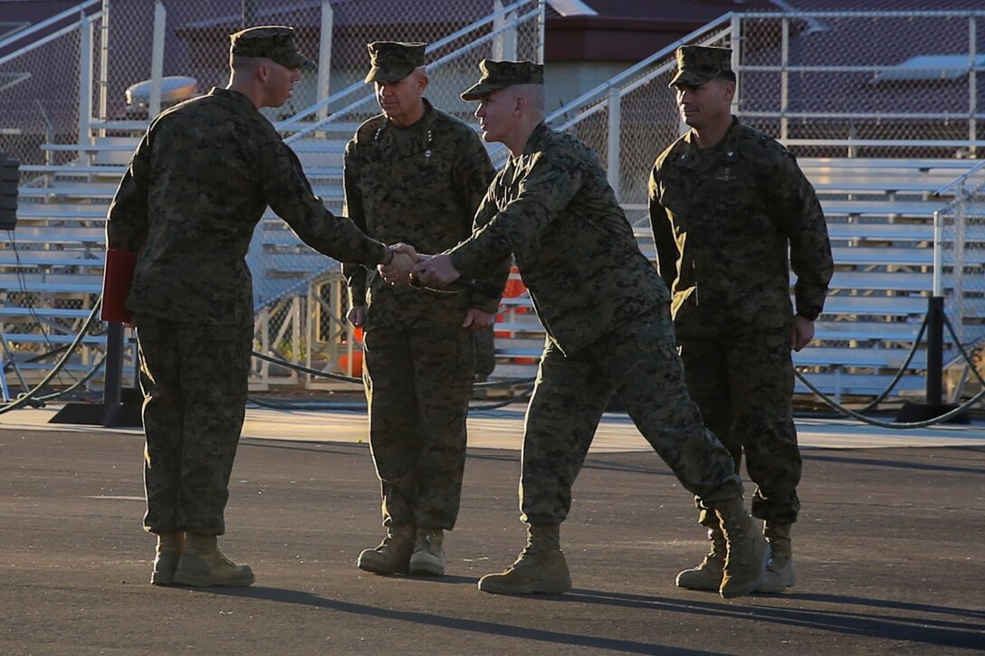 Sgt. Roberto J. Perez, left,  is congratulated by Sgt. Maj. Bradley Kasal after receiving the Navy and Marine Corps Commendation Medal at Camp Pendleton, Feb. 16, 2016. The award was presented to Perez by Lt. Gen. David H. Berger, center, for being selected as the I Marine Expeditionary Force noncommissioned officer of the year. The NCO of the year is awarded to a Marine who exemplifies the highest standards of the Marine Corps, both physically and mentally, and has the ability to inspire Marines. Perez is a squad leader with 2nd Battalion, 5th Marine Regiment, 1st Marine Division. Kasal is the sergeant major of I Marine Expeditionary Force. Berger is the commanding general of I MEF. (U.S. Marine Corps photo by Pvt. Robert Bliss)