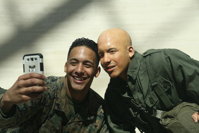 Cpl. Jhon Espinal takes a selfie Feb. 18 with the cast figure he modeled for last year. He portrayed an ammunition gunner exiting a helicopter in a Vietnam War scene for the National Museum of the Marine Corps. The scene will be on display when the museum reopens April 1.