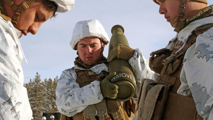 Lance Cpl. Joany Echeverry, cannoneer with Combined Arms Company, assists other team members in collecting the ammunition for a live-fire shoot in Rena, Norway, Feb. 23, 2016, in preparation for Exercise Cold Response 16. The exercise will include 12 NATO allies and partner nations, and approximately 16,000 troops. The Marines will provide indirect fire support for infantry units during the exercise.