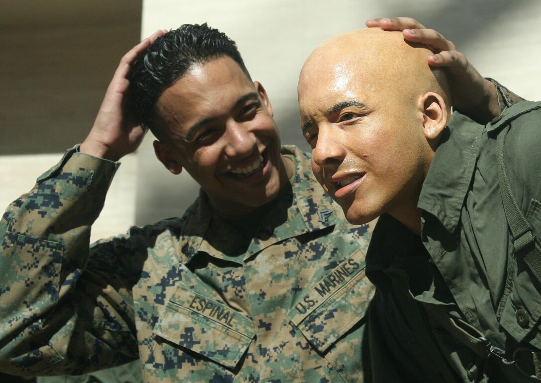 Cpl. Jhon Espinal poses with the cast figure for which he was the model. The cast figure is of an ammunitions gunner deploying from a UH-34D helicopter. The cast figure will be part of a new scene set in 1965, during the Vietnam War, for the National Museum of the Marine Corps’s Leatherneck Gallery. The scene will be on display when the museum reopens April 1.