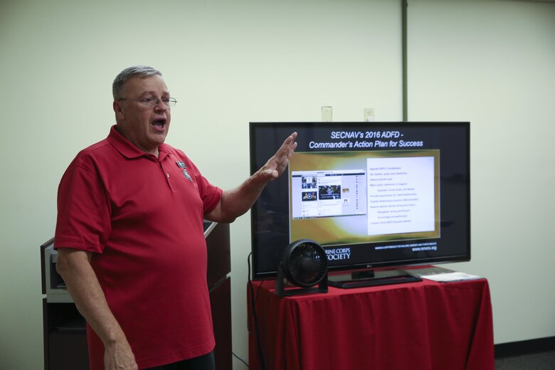 Ray Caldwell, director of the Navy-Marine Corps Relief Society, Twentynine Palms Branch, explains the purpose of the Active Duty Fund Drive to Combat Center Unit representatives at the Village Center, Feb. 19, 2016. (Official Marine Corps photo by Cpl. Thomas Mudd/Released)