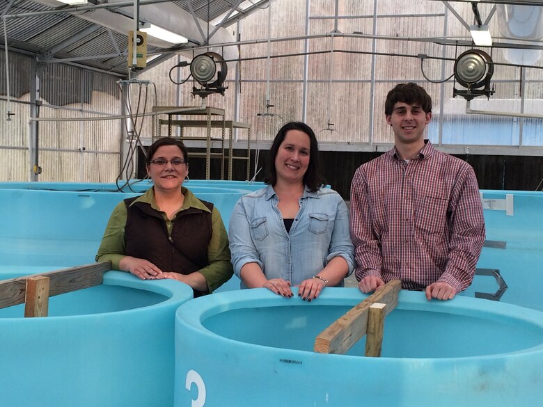Last summer, researchers at ERDC reached out to the Louisville water quality team to provide samples of different types of HABs to use in research projects. Above, Jennifer Thomason (left), Jade Young and Zac Wolf, the district water quality team, stand behind drums containing HAB samples from Louisville District reservoirs. 