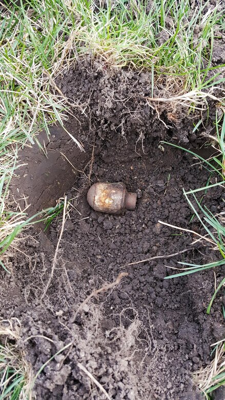 A M406 40 mm grenade is uncovered near a housing area. The unexploded ordnance is a reminder for anyone finding ordnance to recognize, retreat and report the ordnance.