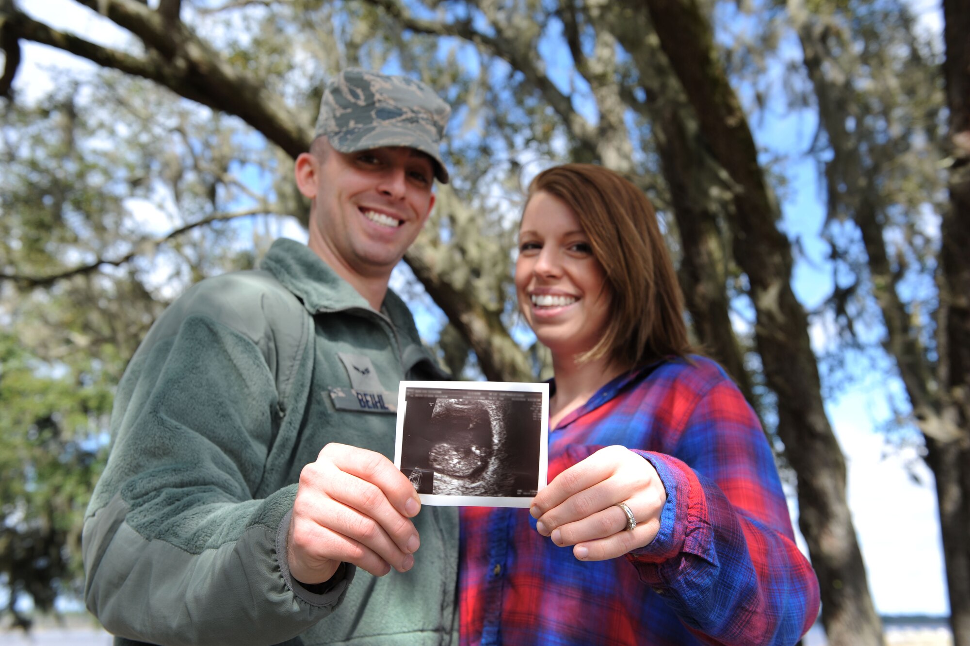 Airman 1st Class Travis Beihl, 81st Training Wing Public Affairs photojournalist, and his wife Erin hold an ultrasound photo of their first child at The Marina Feb. 24, 2016, on Keesler Air Force Base, Miss. The Beihl family found out they are expecting their first child shortly after arriving to Keesler which is their first duty station. (U.S. Air Force photo by Kemberly Groue)