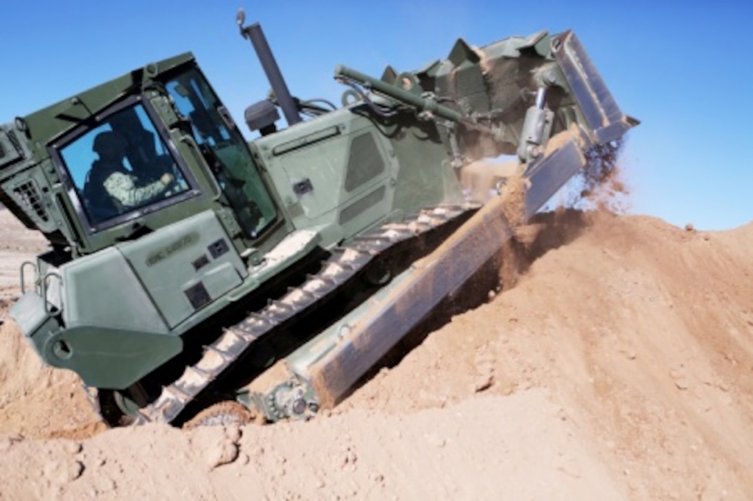 Lance Cpl. Aaron Copley, a heavy equipment operator with Headquarters and Support Company, Combat Logistics Battalion 5, 1st Marine Logistics Group, uses a 626 KR Tram to build a mechanized vehicle fighting position aboard Marine Corps Air Ground Combat Center Twentynine Palms, Calif., Feb. 8, 2016. Marines and Sailors with CLB-5 are participating in Integrated Training Exercise 2-16 in order to prepare their Marines for an upcoming deployment with Special Purpose Marine Air Ground Task Force – Crisis Response – Central Command, as well as increase the proficiency and capabilities of their unit as a whole.