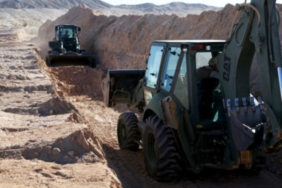 Heavy equipment operators with Headquarters and Support Company, Combat Logistics Battalion 5, 1st Marine Logistics Group, uses 420E Back Hoe create a 200 meter long defensive tank trench aboard Marine Corps Air Ground Combat Center Twentynine Palms, Calif., Feb. 8, 2016. Marines and Sailors with CLB-5 are participating in Integrated Training Exercise 2-16 in order to prepare their Marines for an upcoming deployment with Special Purpose Marine Air Ground Task Force – Crisis Response – Central Command, as well as increase the proficiency and capabilities of their unit as a whole.