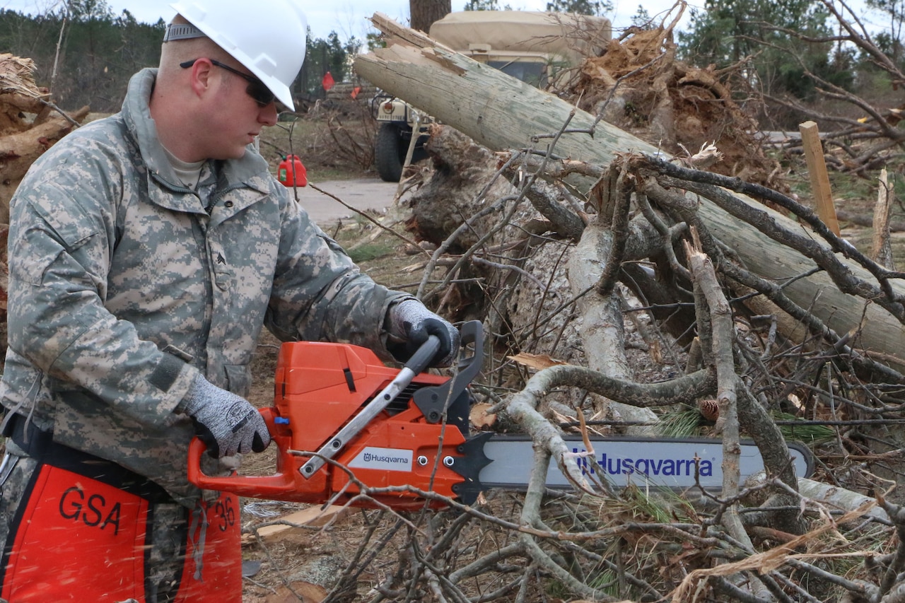 Virginia National Guard soldiers clear debris to open a blocked road in Essex County, Va., Feb. 25, 2016. More than 40 Virginia National Guard soldiers are on state active duty assisting with cleanup operations. Virginia National Guard photo by Cotton Puryear