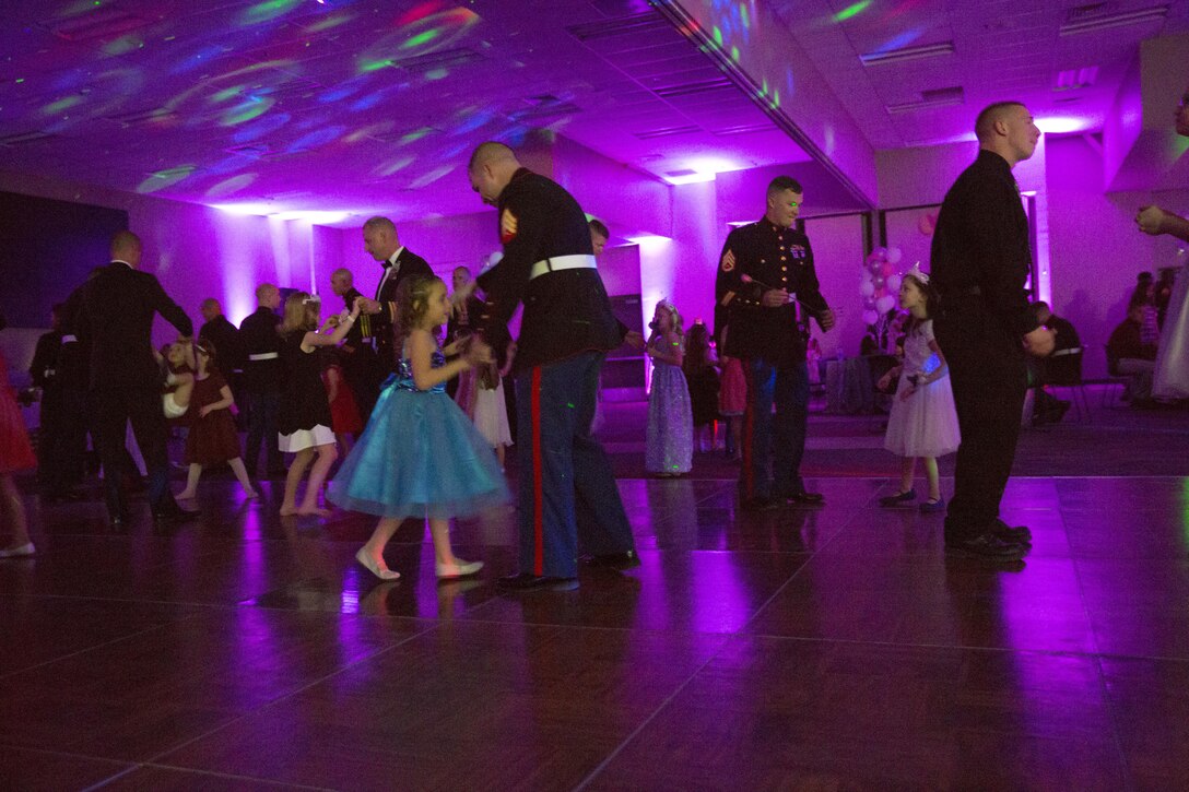 Marines and their daughters dance together during the Father Daughter Dance at Building 1707 Feb. 20, 2016. Marine Corps Community Services hosted the event to provide an opportunity for Marines and sailors to spend time with their daughters. (Official Marine Corps photo by Lance Cpl. Levi Schultz/Released)