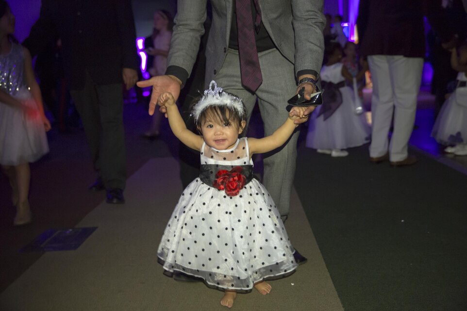 A Marine with 1st Battalion, 7th Marine Regiment, dances with his daughter during the Father Daughter Dance at Building 1707 Feb. 20, 2016. Marine Corps Community Services hosted the event to provide an opportunity for Marines and sailors to spend time with their daughters. (Official Marine Corps photo by Lance Cpl. Levi Schultz/Released)