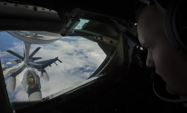 Airman 1st Class Payten Olsen, 909th Air Refueling Squadron boom operator, refuels an 18th Aggressor Squadron F-16C Fighting Falcon during the large force employment of exercise Cope North 16, Feb. 24, 2016, at Andersen Air Force Base, Guam. Through training exercises such as CN16, the U.S., Japan and Australian air forces develop combat capabilities, enhancing air superiority, electronic warfare, air interdiction, tactical airlift and aerial refueling. (U.S. Air Force photo by Staff Sgt. Matthew B. Fredericks/Released)