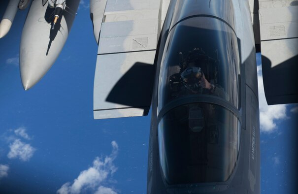 A 44th Fighter Squadron F-15 Eagle pilot signals completion of aerial refueling from a 909th Air Refueling Squadron KC-135 Stratotanker during the large force employment of exercise Cope North 16, Feb. 24, 2016, at Andersen Air Force Base, Guam. Through training exercises such as CN16, the U.S., Japan and Australian air forces develop combat capabilities, enhancing air superiority, electronic warfare, air interdiction, tactical airlift and aerial refueling. (U.S. Air Force photo by Staff Sgt. Matthew B. Fredericks/Released)