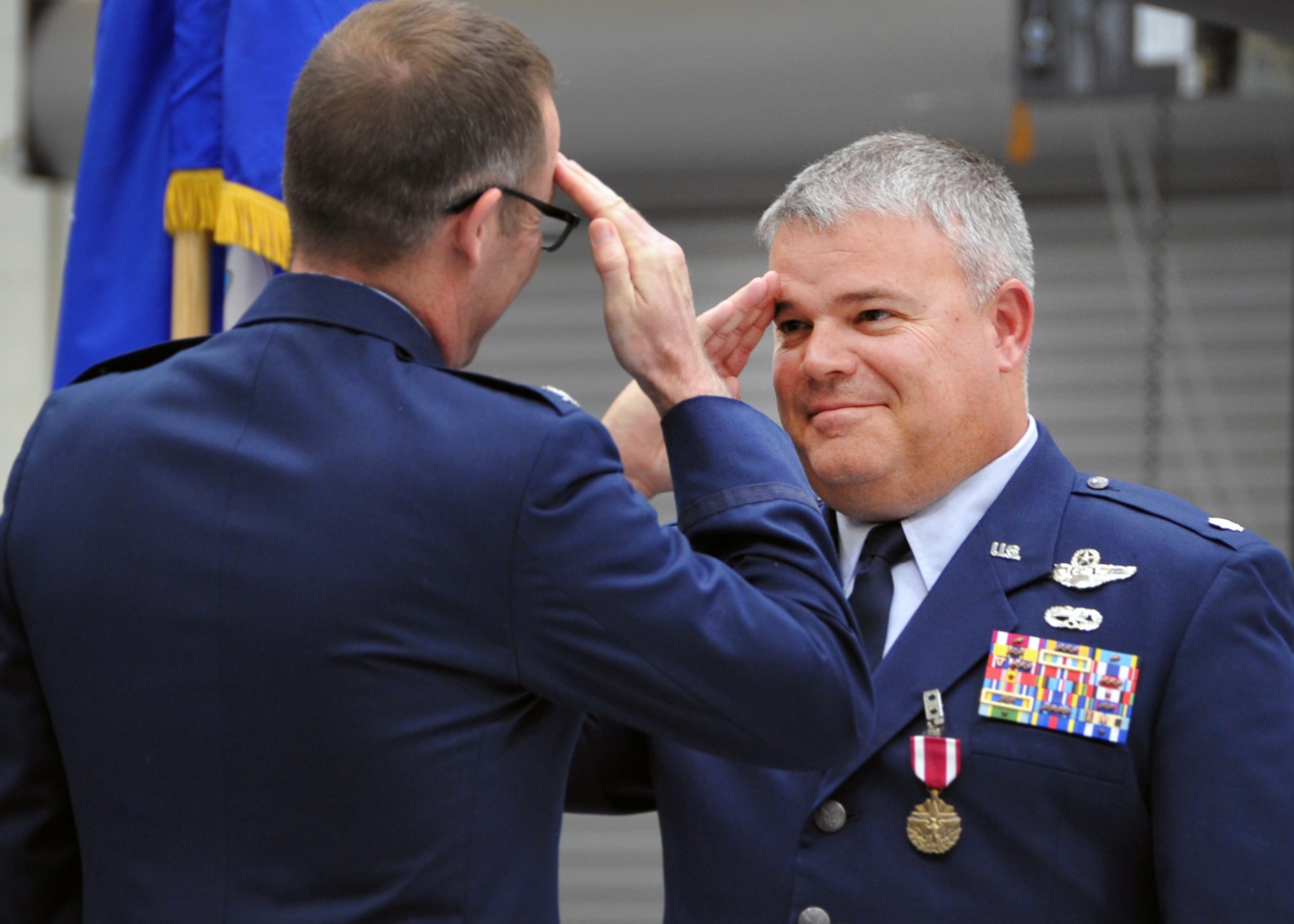 U.S. Air Force Reserve Lt. Col. Jeff “Spanky” Peterson salutes Col. Matthew Burger upon the presentation of his Meritorious Service Medal during his retirement ceremony after 25 years of service at Davis-Monthan Air Force Base, Ariz., Feb. 19. Spanky was a career HH-60 helicopter pilot assigned to the 305th Rescue Squadron here and was part of the Afghanistan rescue mission made famous by Mark Wahlberg in the movie “Lone Survivor.” During that 2005 mission, he ex-filtrated U.S. Navy SEAL Marcus Luttrell, who survived a four-man firefight against 200 Taliban. (U.S. Air Force photo by Carolyn Herrick)