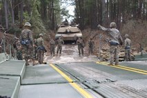 Marines with 2nd Tank Battalion, 2nd Marine Division and 8th Engineer Support Battalion, 2nd Marine Logistics Group, traverse the New River from Camp Lejeune, N.C., Feb. 22, 2016. Marines from 8th ESB provided the means for transportation as they loaded all the armor and personnel upon their Seven-Bay Raft systems. The river crossing was part of a weeklong, large-scale exercise known as Iron Blitz. Iron Blitz, a Marine Corps Combat Readiness Evaluation, tested 2nd Tanks in their ability to integrate all aspects of the Marine Air-Ground Task Force and function as a deployment-ready unit. (Marine Corps photo by Cpl. Shannon Kroening)