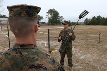 Sgt. Dereck Ford, a technician with Explosive Ordnance Disposal Company, teaches Marines with Combat Logistics Battalion 2 how to power up and recalibrate a metal detector during an improvised explosive device training exercise at Camp Lejeune, N.C., Feb. 23, 2016. CLB-2 Marines learned how to recognize signs of an IED and use the detector to identify the type of IED that may be present as they conducted hands-on training in preparation for their upcoming deployment with Special Purpose Marine Air Ground Task Force Crisis Response Africa. (U.S. Marine Corps photo by Lance Cpl. Aaron K. Fiala/Released)