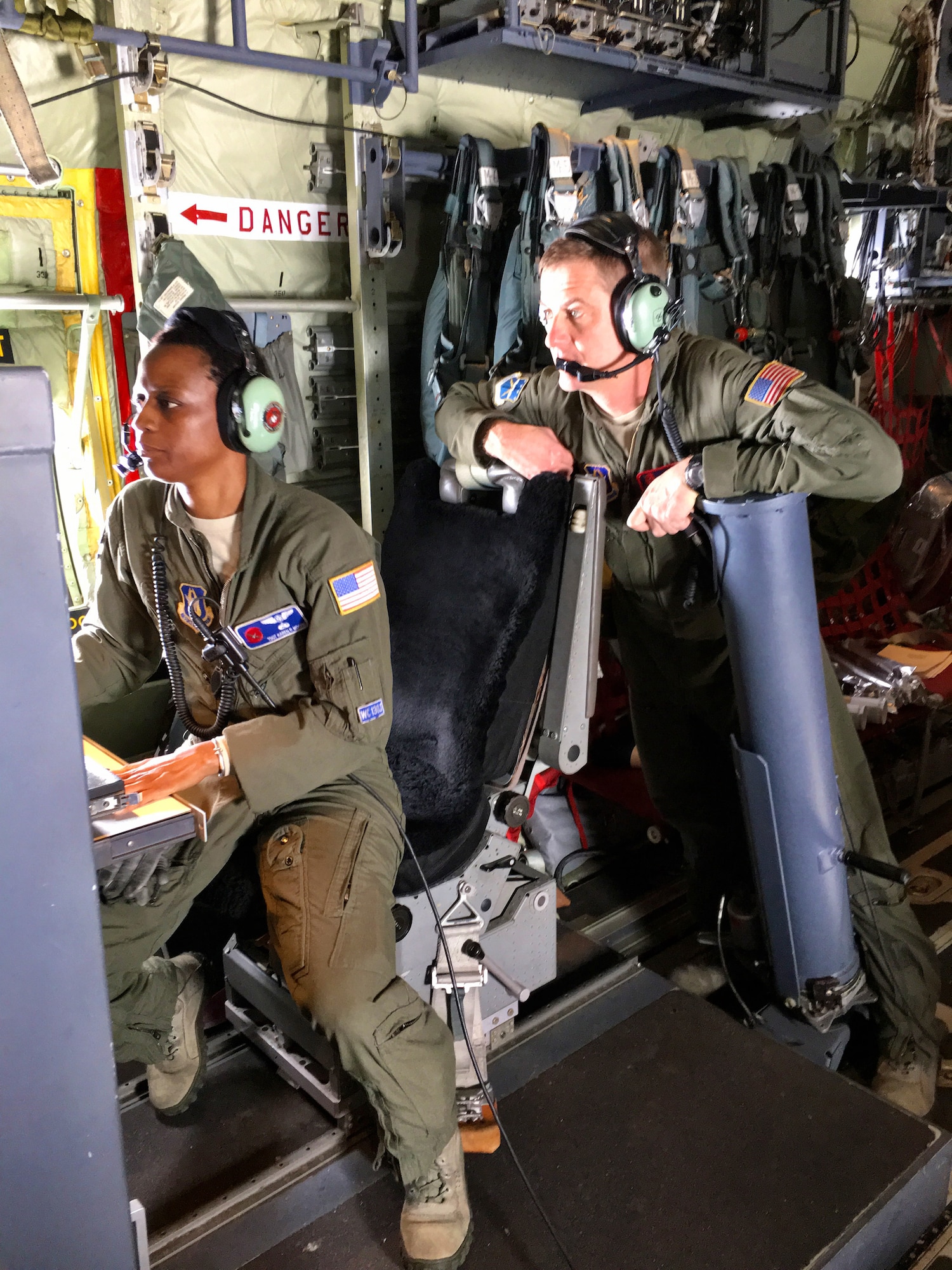 Tech. Sgt. Karen Moore and Chief Master Sgt. Rick Cumbo, 53rd Weather Reconnaissance Squadron loadmasters, analyze weather data being relayed to the aircraft by a dropsonde, a parachute-borne cylindrical instrument that collects meteorological data as it drops toward the surface of the water. The Hurricane Hunters flew several research missions Feb. 11-24, 2016, to collect meteorological data from atmospheric rivers above the Pacific to assist in improving West Coast weather forecasts. (U.S. Air Force photo/Capt. Kimberly Spusta) 
