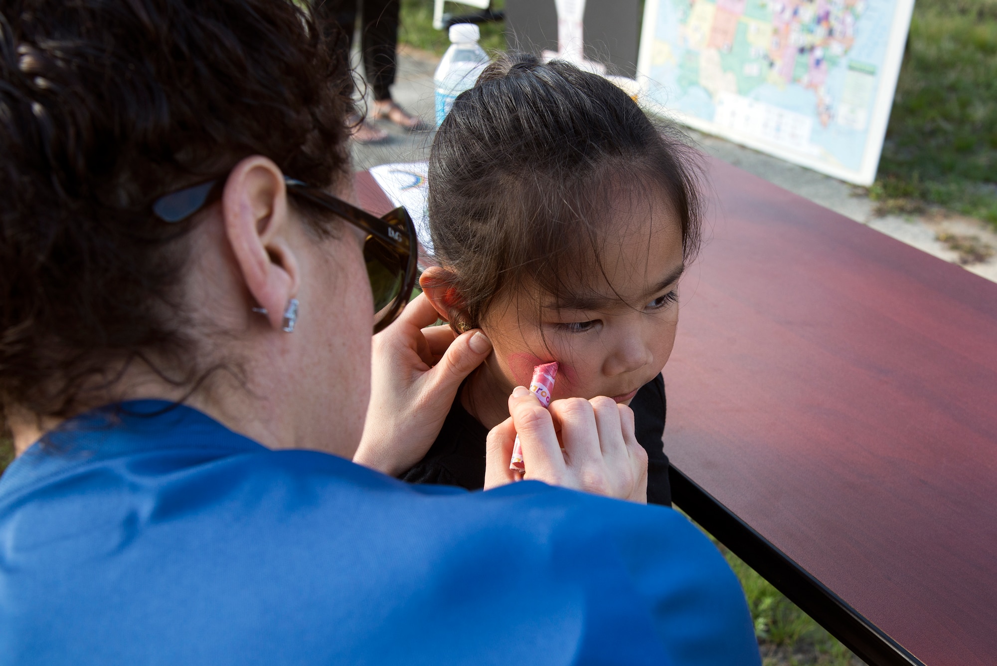 Jacinda Salas, daughter of U.S. Air Force Staff Sgt. Mariano Salas, 723d Aircraft Maintenance Squadron electronic warfare craftsman, gets her face painted during the Literacy Fair, Feb. 23, 2016, at Moody Air Force Base, Ga. The event featured face-painting, various activities, free snacks and drinks, for participants to partake in. (U.S. Air Force photo by Airman 1st Class Janiqua P. Robinson/Released)