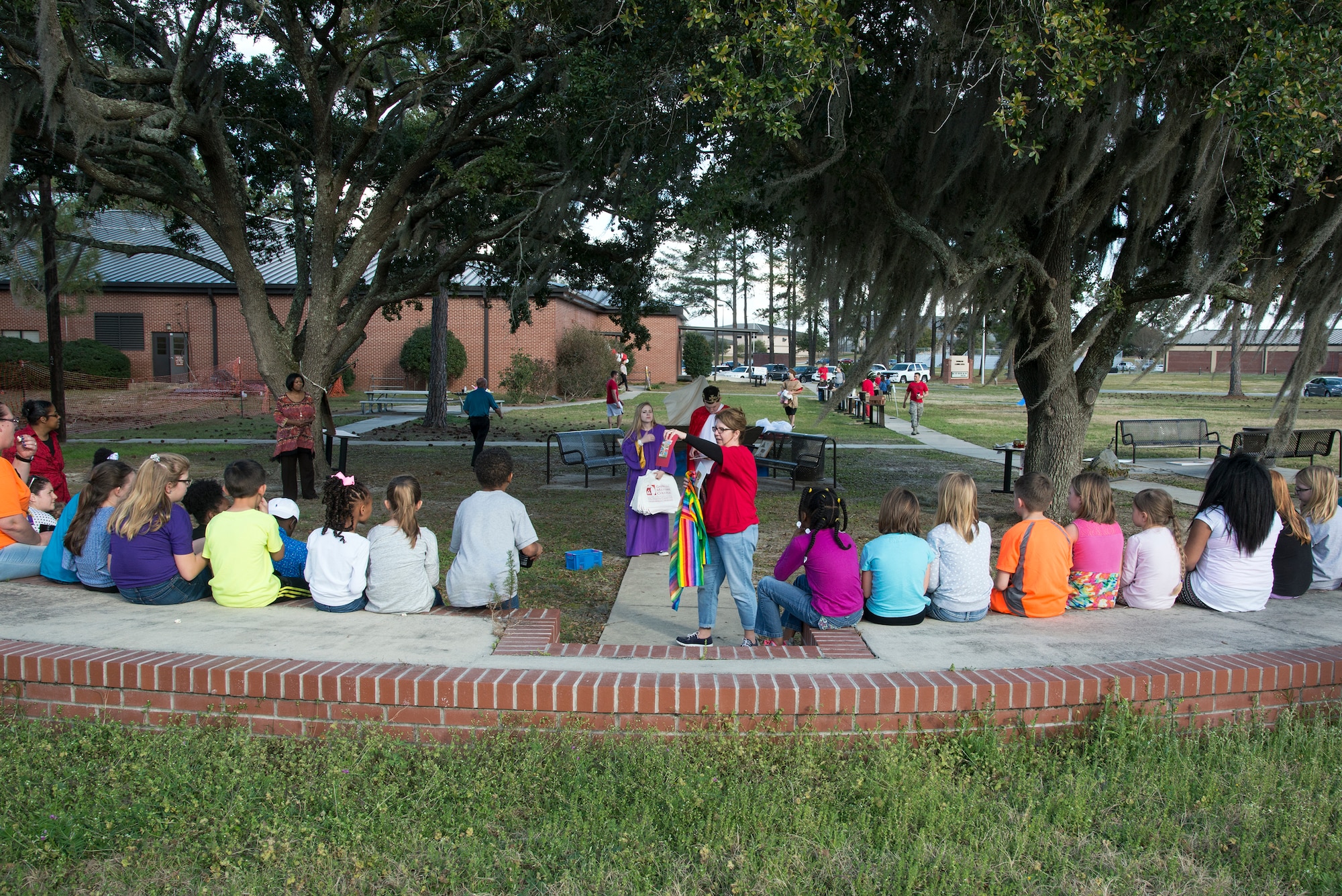 Children listen to Mary Preston, local college student, read a story during the Literacy Fair, Feb. 23, 2016, at Moody Air Force Base, Ga. The story, which was from the Bible, was about Joseph and his cloak of many colors and all the trials and tribulations he had to go through because of his brother’s jealousy. (U.S. Air Force photo by Airman 1st Class Janiqua P. Robinson/Released)