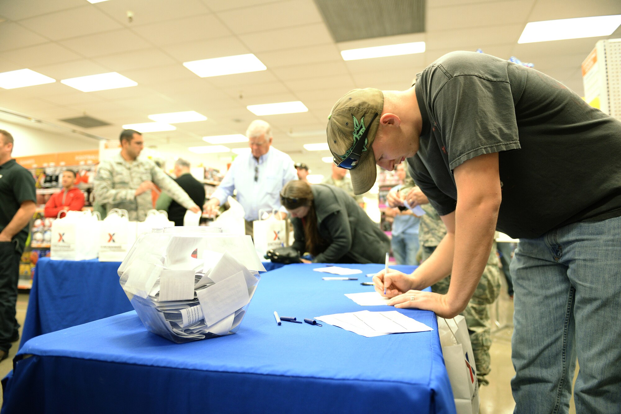 Senior Airman Austin Kauffman, enters a raffle for a free drawing at the newly renovated Base exchange gun shop at Beale Air Force Base, California, Feb 25, 2016. The approximate $1.9 million project included new flooring, a floor plan to accommodate an expanded product line, new displays and a new central checkout location.