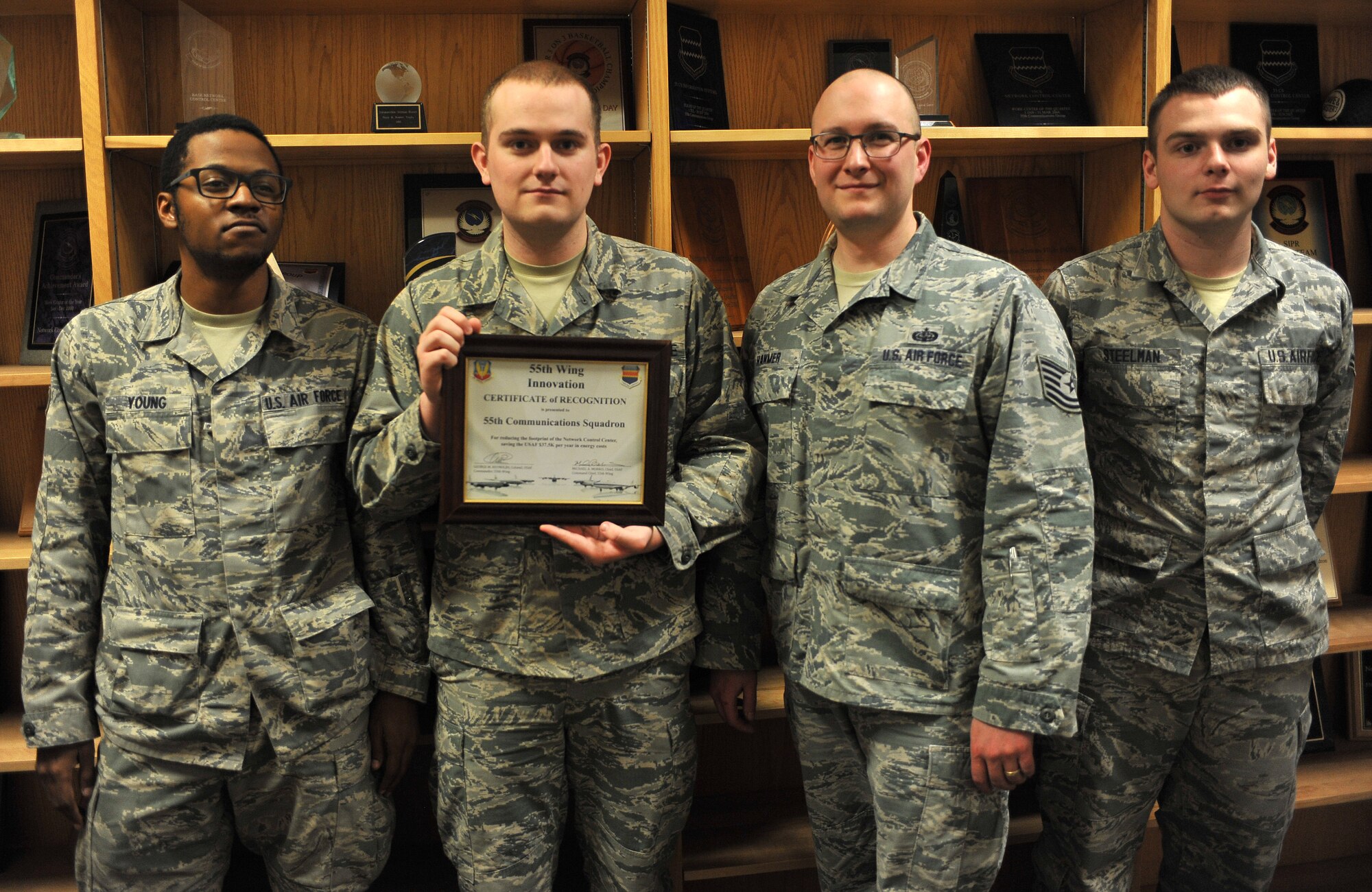 Senior Airman Marquez Young, left, Airman 1st Class Nathaniel Layman, Tech. Sgt. Nathan Hanmer and Airman 1st Class Dominic Steelman, all with the 55th Communications Squadron at Offutt Air Force Base, Neb., hold a 55th Wing Innovation Certificate of Recognition Feb. 23, 2016. They received the award at a recent commander’s call after saving the wing $37,500 in annual energy costs. (U.S. Air Force photo/Senior Airman Rachel Hammes) 