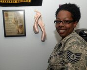Technical Sgt. Niki Molinar, Paul W. Airey NCO Academy instructor, sits next to her ballet shoes posted on her office wall at the academy Feb. 24, 2016. Molinar credits much of her leadership ability to the discipline and creative skills she learned while teaching dance classes. (U.S. Air Force photo by Airman 1st Class Cody R. Miller/Released)  