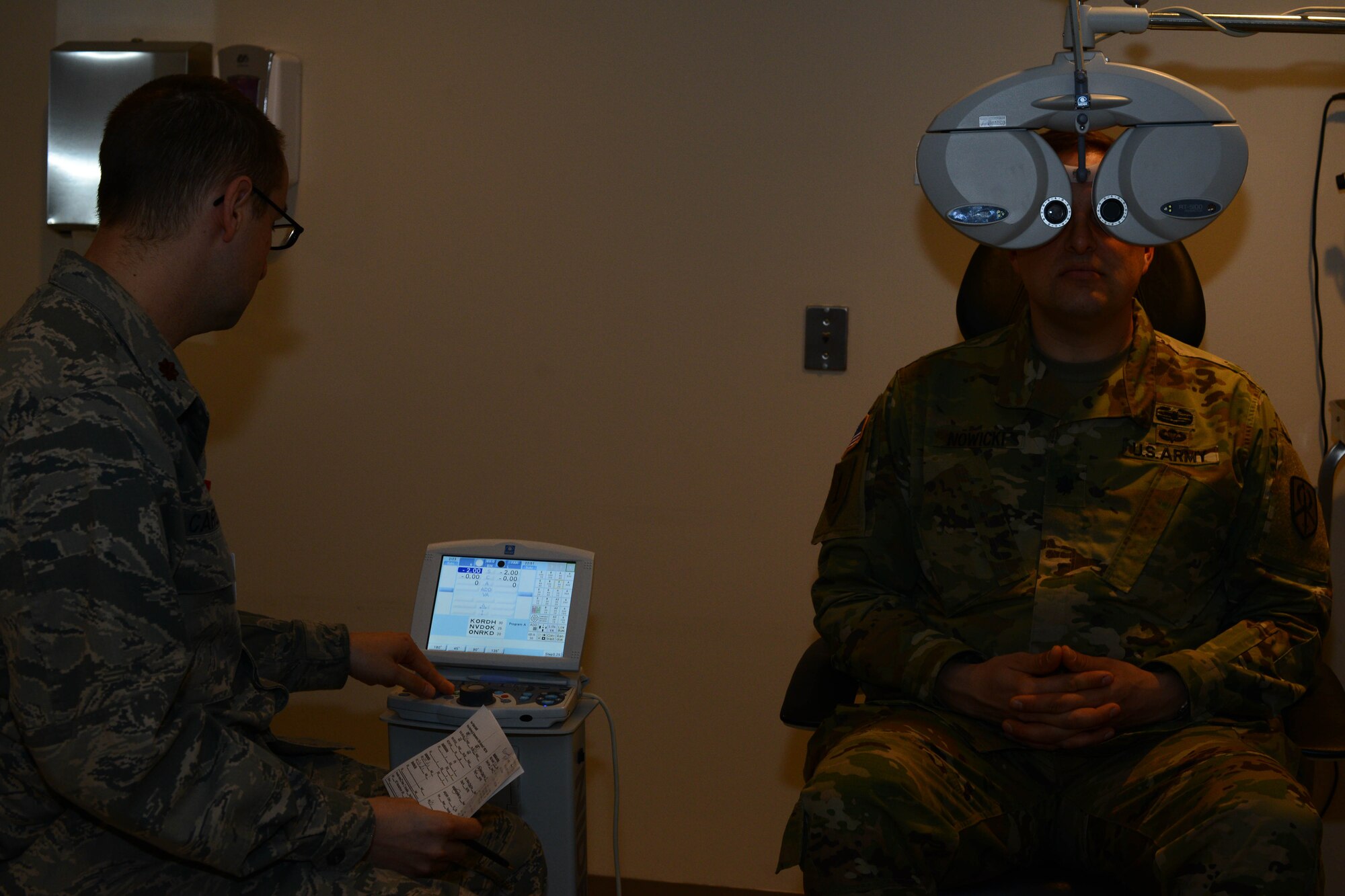 Maj. Robert Carlsen, 22nd Aerospace Medical Squadron optometry flight commander, operates a phoropter during an eye exam, Feb. 24, 2016, at McConnell Air Force Base, Kan. The phoropter is used to fine-tune adjustments of a patients prescription during eye exams. (U.S. Air Force photo/Airman 1st Class Christopher Thornbury)
