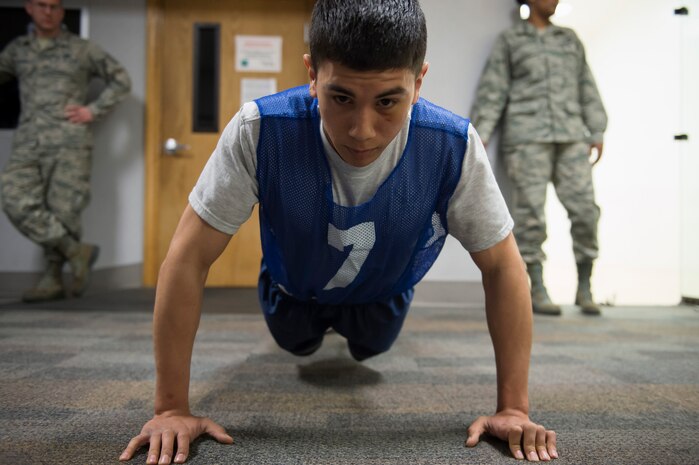 Senior Airman Erik Licon, a Raven apprentice student, does push-ups during a three-week Phoenix Raven apprentice course Feb. 17, 2016 at Joint Base Charleston, S.C. Ravens are teams of specially trained security forces personnel dedicated to providing security for AMC aircraft transiting through high terrorist and criminal threat areas. (U.S. Air Force photo/Staff Sgt. Jared Trimarchi) 