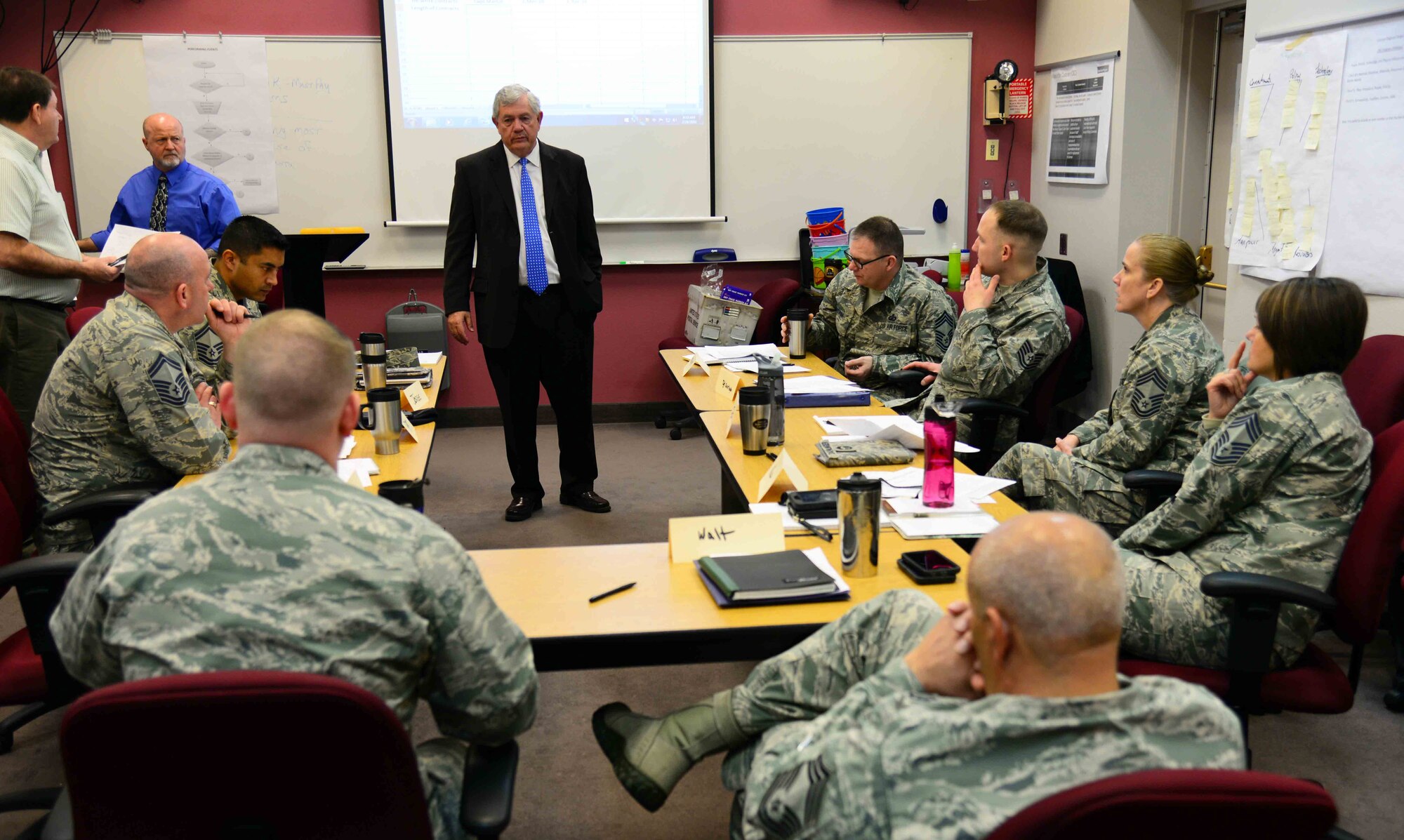 Carroll Correll, 341st Force Support Squadron co-facilitator, center, assists 341st Missile Wing senior leaders in conducting a Continuous Process Improvement event Feb. 25, 2016, at Malmstrom Air Force Base, Mont. CPI team members discussed the issues associated with honor guard manning and after a consensus is made for a solution, will provide recommendations for policy changes to wing leadership. (U.S. Air Force photo/Airman 1st Class Magen M. Reeves)