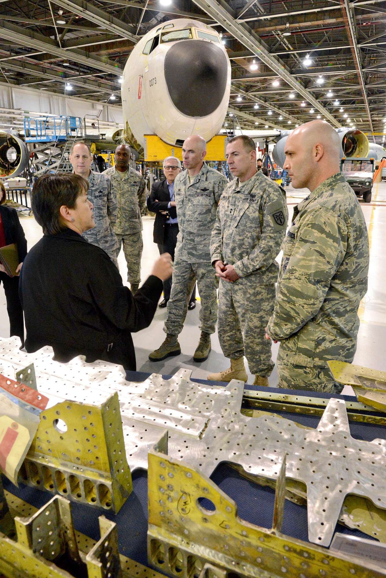 Theresa Farris, 564th Aircraft Maintenance Squadron civilian leader, explains the KC-135 PDM Line to Commanders Summit participants Feb. 19. Pictured are, from left, Air Force Lt. Gen. Lee Levy II, Air Force Sustainment Center commander; Air Force Col. Kenyon Bell, 76th Aircraft Maintenance Group; retired Army Maj. Gen. Myles L. Deering, Oklahoma Secretary of Veterans Affairs; Air Force Col. Clark J. Quinn, 71st Flying Training Wing commander, Vance Air Force Base; Army Maj. Gen. John G. Rossi, Fort Sill commanding general; and Air Force Col. Todd A. Hohn, 97th Air Mobility Wing, Altus Air Force Base.  (Air Force photo by Kelly White/Released)