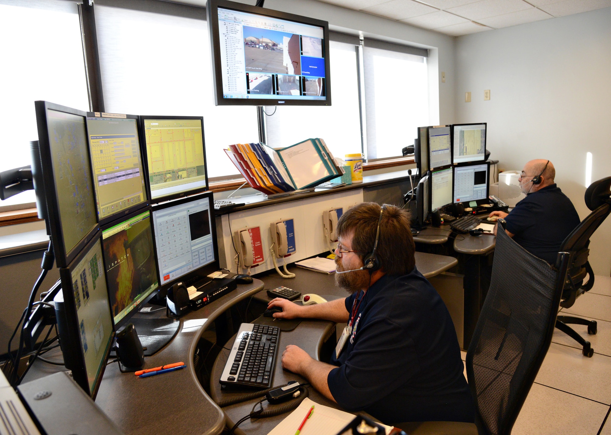 John Adkerson and Michael Sellers, both Emergency Communications Center Operators, field Tinker’s 911 calls and dispatch emergency crews to action wherever they are needed. Their office staffs eight dispatchers total and two dispatchers are on-duty at all times and work 60-hour work weeks. They are all trained in emergency medical and fire dispatching, as well as CPR and hazardous material awareness. (Air Force photo by Kelly White/Released)