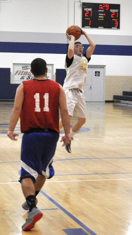 Justin Durso of 552 AMXS sails a high jump shot Feb. 17 with some space away from 507/513/35 Reserves’ Brian Watson. AMXS edged Reserves 42-40 in a close game at the Gerrity Fitness Center.   (Air Force photo by John Parker/Released)
