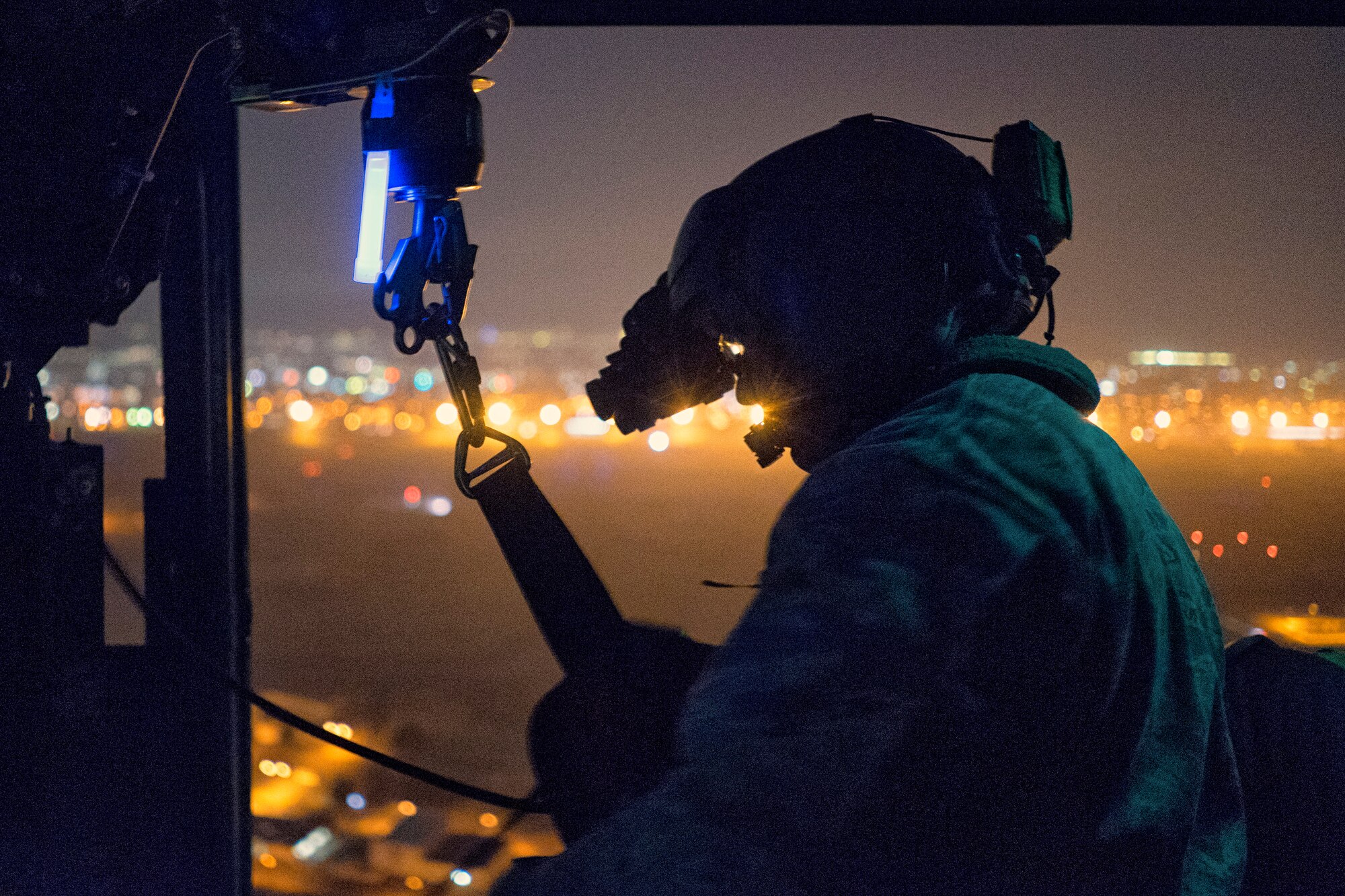 Tech. Sgt. Michael Wright, 459th Airlift Squadron UH-1N Huey flight engineer, reels in a UH-1N hoist cable at Yokota Air Base, Japan, Feb. 23, 2016. For 459 AS’ special missions aviators to become certified to operate the hoist, SMA instructors with the 512th Rescue Squadron, Kirtland AFB, New Mexico, and the 36th RQS, Fairchild AFB, Washington, arrived at Yokota to train alongside flight engineers. The requalification process included day and night hoist operations with instructor supervision. (U.S. Air Force photo by Airman 1st Class Delano Scott/Released)
