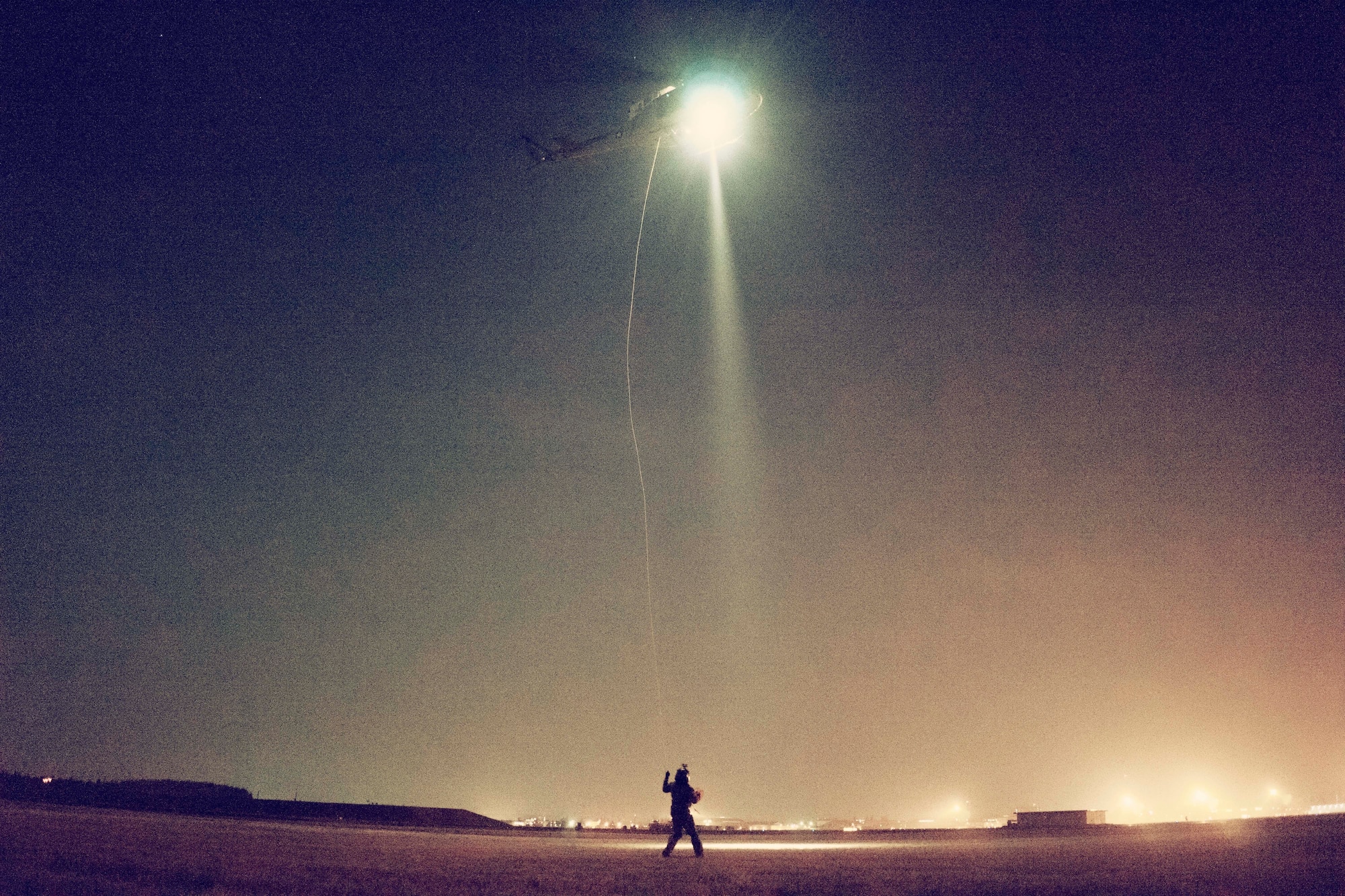 Tech. Sgt. Michael Wright, 459th Airlift Squadron UH-1N Huey flight engineer, handles a UH-1N hoist cable at Yokota Air Base, Japan, Feb. 23, 2016. For 459 AS’ special missions aviators to become certified to operate the hoist, SMA instructors with the 512th Rescue Squadron, Kirtland AFB, New Mexico, and the 36th RQS, Fairchild AFB, Washington, arrived at Yokota to train alongside flight engineers. The requalification process included day and night hoist operations with the supervision of instructors. (U.S. Air Force photo by Airman 1st Class Delano Scott/Released)