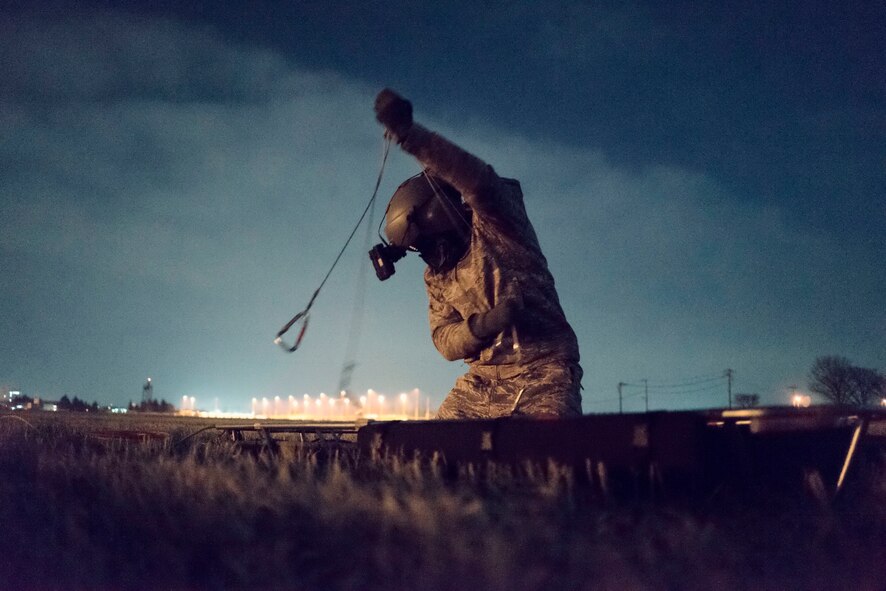 Tech. Sgt. Michael Wright, 459th Airlift Squadron UH-1N Huey flight engineer, prepares stokes litter for hoisting at Yokota Air Base, Japan, Feb. 23, 2016. The 459 AS recently improved their search and rescue capabilities by outfitting two UH-1N Hueys with new rescue hoists. Previously, without the hoist, conducting rescues in small, tight areas wasn’t feasible. Now, 459 AS aircrew can conduct any type of search and rescue scenario throughout the Kanto Plains. (U.S. Air Force photo by Airman 1st Class Delano Scott/Released)