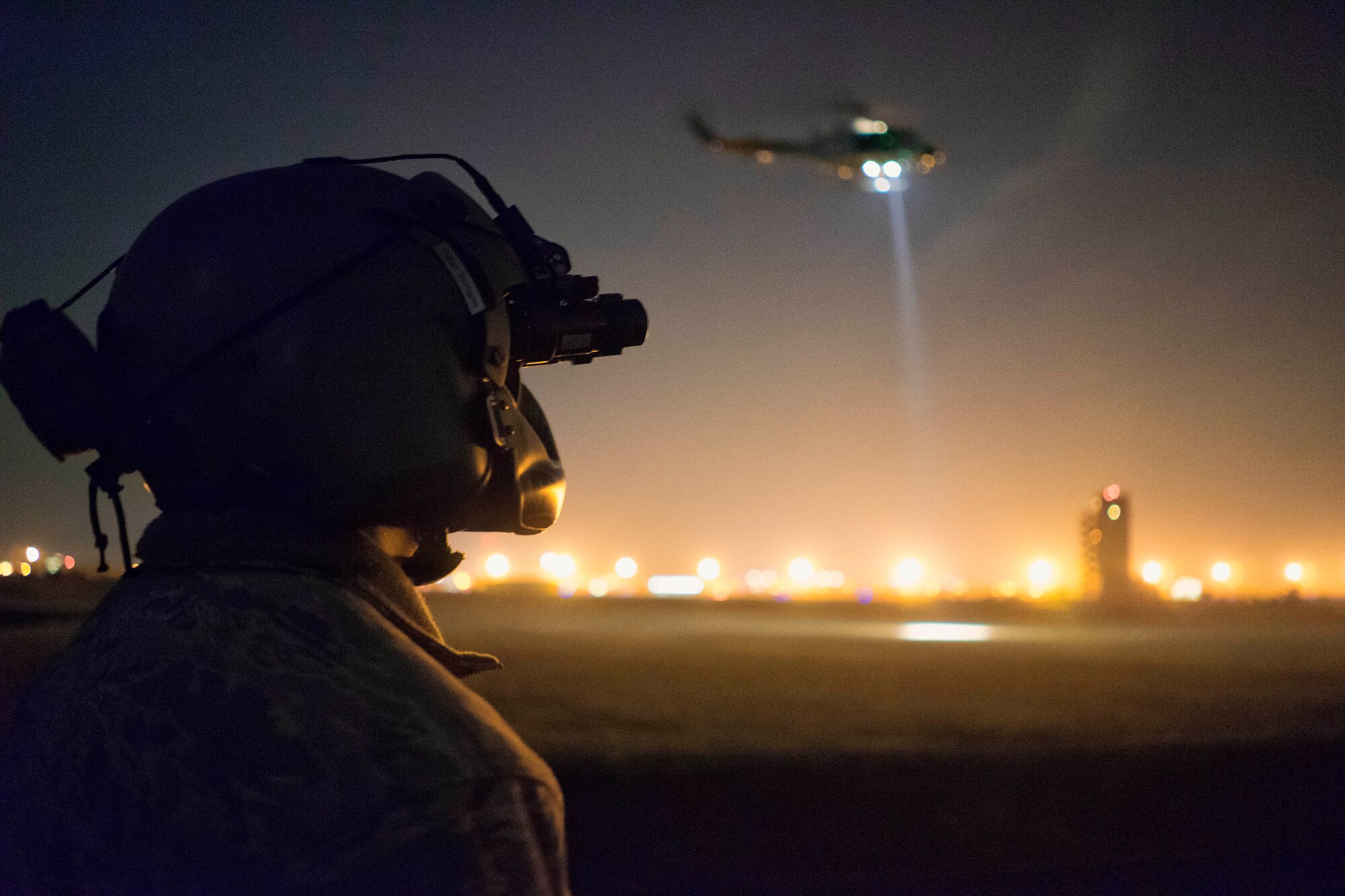 Tech. Sgt. Michael Wright, 459th Airlift Squadron UH-1N Huey flight engineer, watches as a UH-1N prepares to lift a stokes litter at Yokota Air Base, Japan, Feb. 23, 2016. The 459 AS recently improved their search and rescue capabilities by outfitting two UH-1N Hueys with new rescue hoists. Previously, without the hoist, conducting rescues in small, tight areas wasn’t feasible. Now, 459 AS aircrew can conduct any type of search and rescue scenario throughout the Kanto Plains. (U.S. Air Force photo by Airman 1st Class Delano Scott/Released)