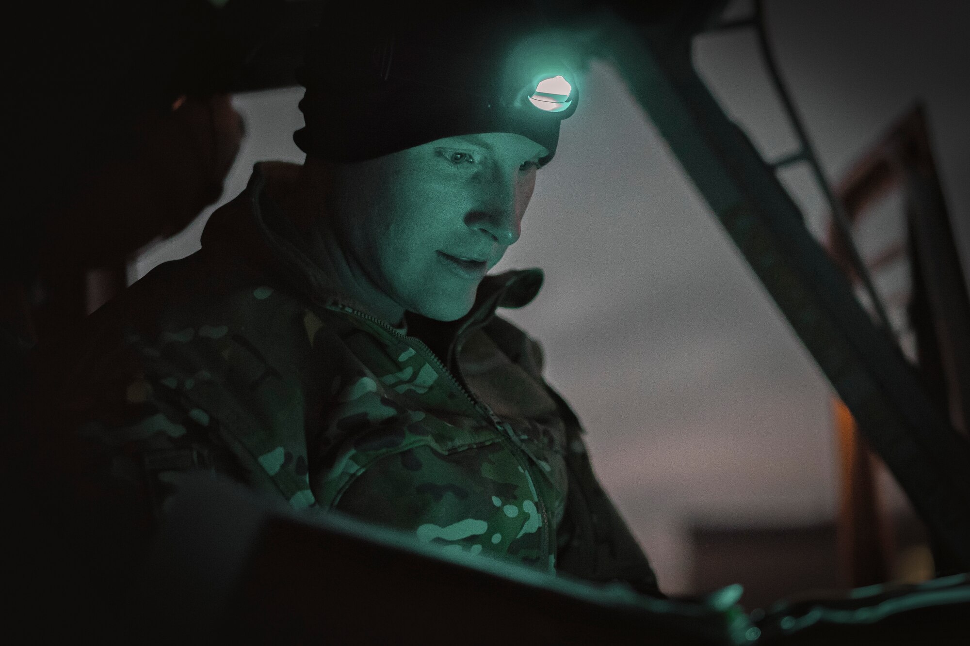 Capt. Robert Konowicz, 512th Rescue Squadron UH-1N Huey pilot, reviews a pre-flight checklist inside of a UH-1N at Yokota Air Base, Japan, Feb. 23, 2016. The 459th Airlift Squadron recently improved their search and rescue capabilities by outfitting two UH-1N Hueys with new rescue hoists. (U.S. Air Force photo by Airman 1st Class Delano Scott/Released)