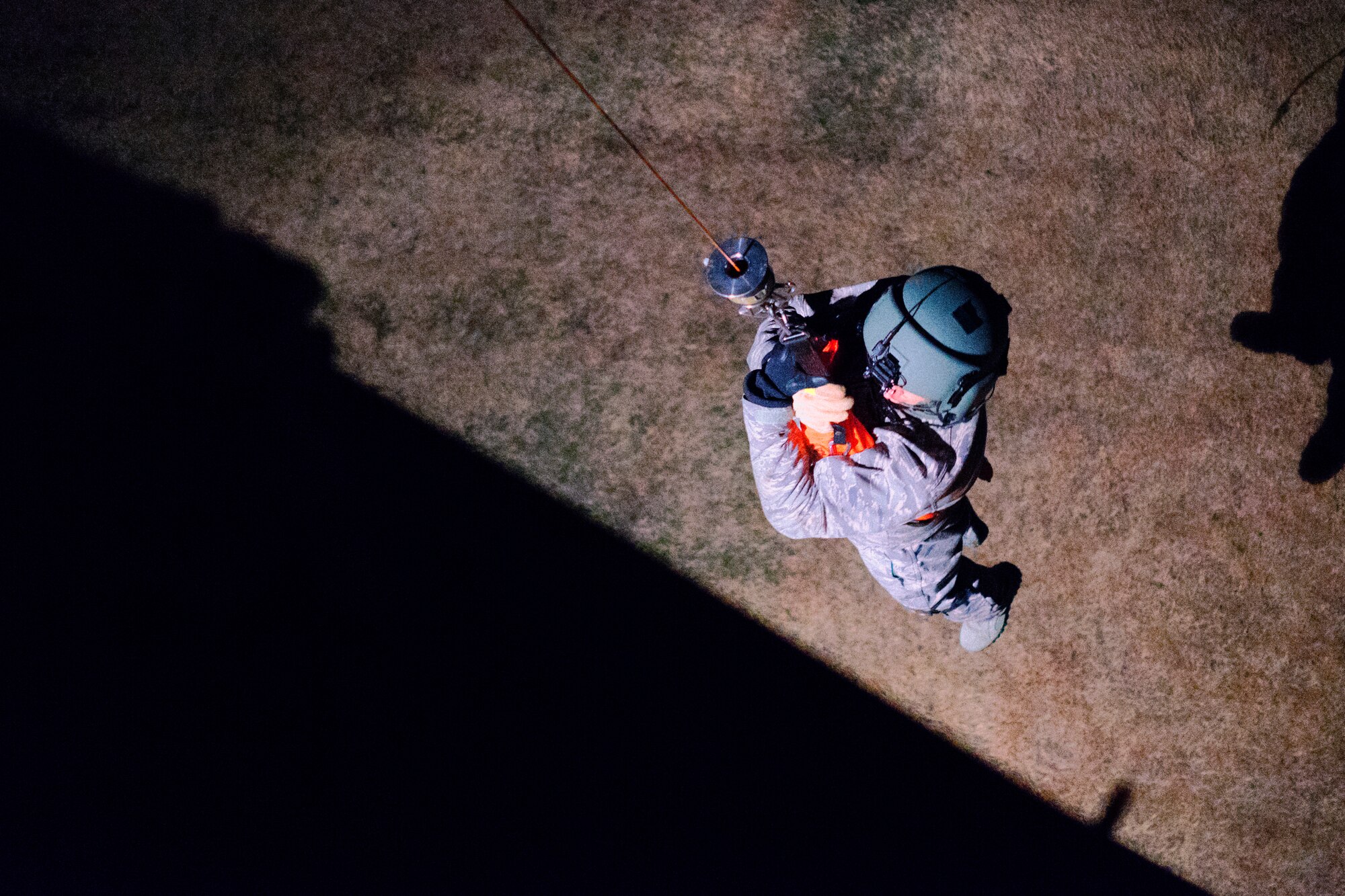 Staff Sgt. Nicholas Poe, 459th Airlift Squadron special missions aviator instructor and UH-1N flight engineer, uses a hoist to raise into the aircraft at Yokota Air Base, Japan, Feb. 23, 2016. For 459 AS’ special missions aviators to become certified to operate the hoist, SMA instructors with the 512th Rescue Squadron, Kirtland AFB, New Mexico, and the 36th RQS, Fairchild AFB, Washington, arrived at Yokota to train alongside flight engineers. (U.S. Air Force photo by Airman 1st Class Delano Scott/Released)