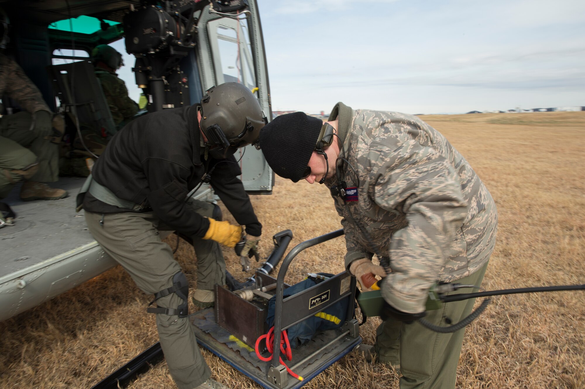 (Left to right) Tech. Sgt. Christopher Pound, 36th Rescue Squadron special missions aviator evaluator, and Tech. Sgt. Christopher Rector, 459th Airlift Squadron flight engineer, hoisted 350 lbs. during a hoist training exercise at Yokota Air Base, Japan, Feb. 22, 2016. The 459 AS recently improved their search and rescue capabilities by outfitting two UH-1N Hueys with new rescue hoists. Previously, without the hoist, conducting rescues in small, tight areas wasn’t feasible. Now, 459 AS aircrew can conduct any type of search and rescue scenario throughout the Kanto Plains. (U.S. Air Force photo by Osakabe Yasuo/Released)  