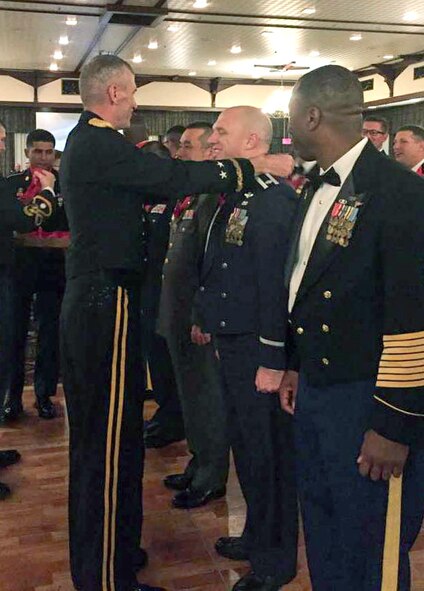 U.S. Army Maj. General Jim Pasquarette, U.S. Army Japan and I Corps (Forward) commander, presents the Order of Saint Barbara medal to U.S. Air Force Lt. Col. Daniel Biehl, 623rd Air Control Flight commander, Feb. 19, 2016, at Camp Foster, Japan. The award, usually reserved for U.S. Army and Marine Corps artillerymen, was presented to Biehl for demonstrating the highest standards of integrity and moral character, displaying an outstanding degree of professional competence and contributing to the promotion of the Field Artillery or Air Defense Artillery. (courtesy photo)