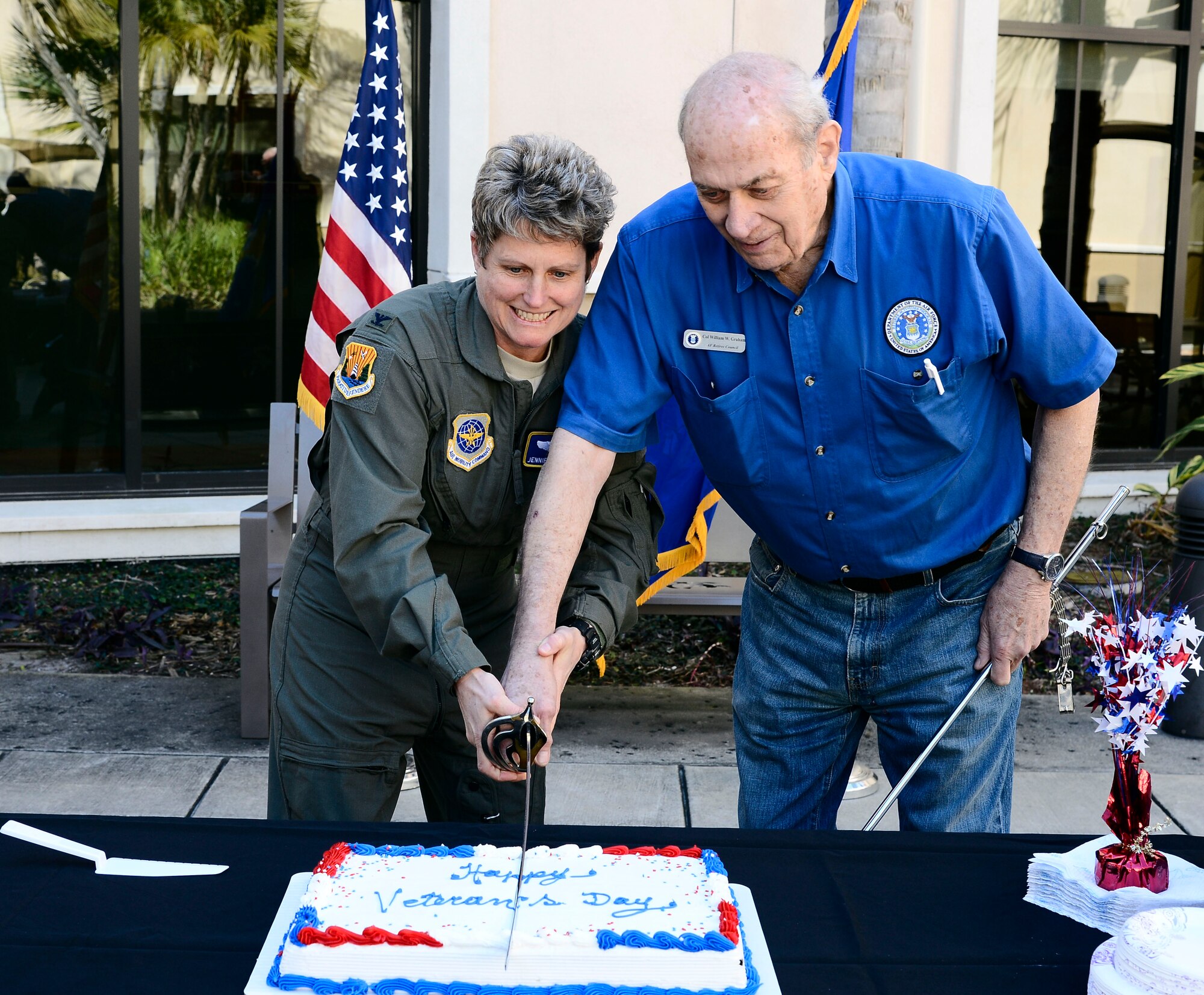 Col. Jennifer Crossman, vice commander of the 6th Air Mobility Wing, left, and retired Col. Billy Graham, director of the Retiree Activities Office, right, cut a cake during Retiree Appreciation Day at MacDill Air Force Base, Fla., Feb. 11, 2016. Retirees from every branch of service were offered first come first serve service at specific offices on MacDill to update their knowledge on retiree benefits and entitlements. (U.S. Air Force photo by Senior Airman Tori Schultz)
 
