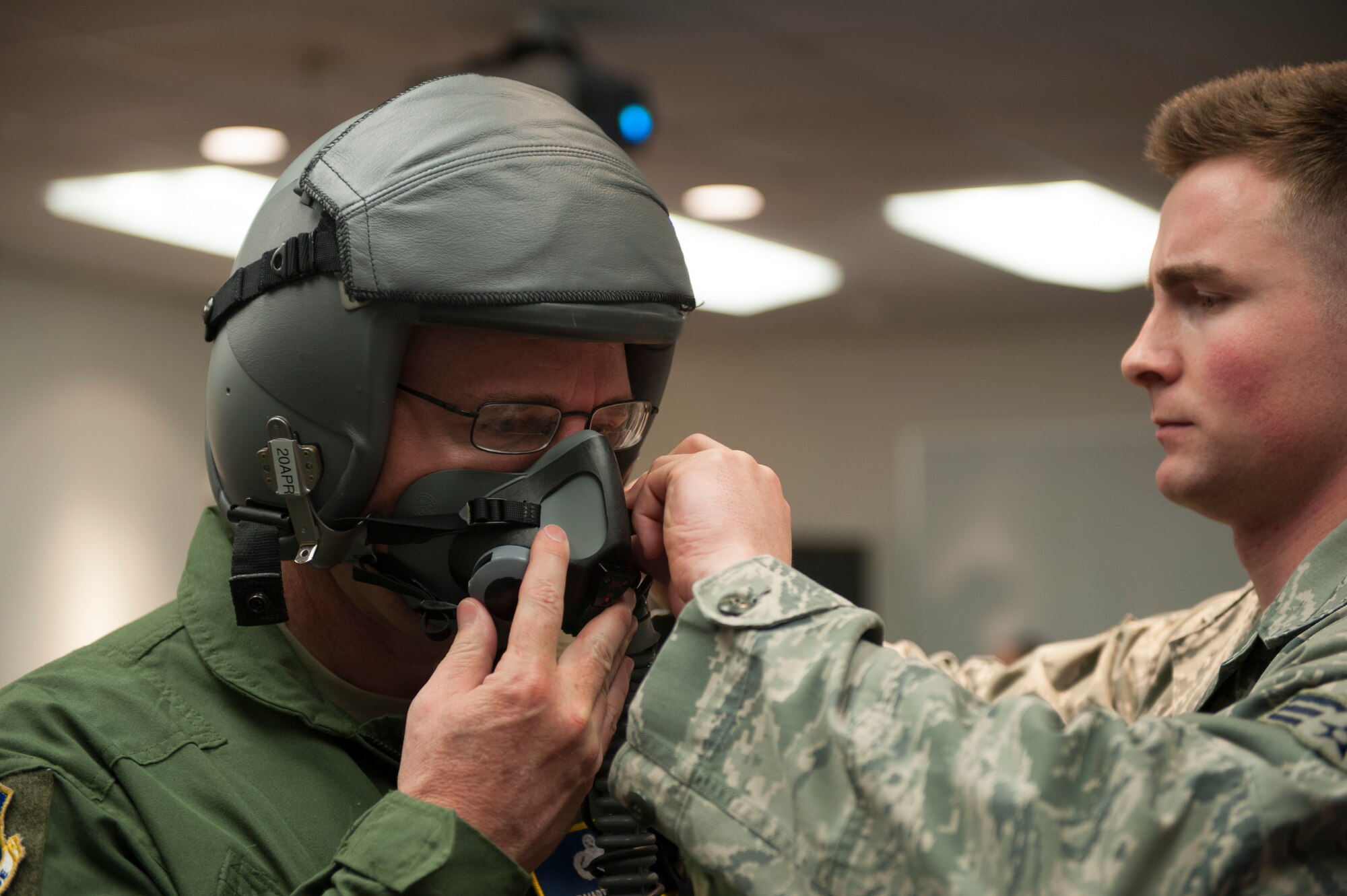 U.S. Air Force Chief Master Sgt. Marty Anderson, 8th Air Force command chief (left), is being fitted for a flight helmet by Senior Airman Conner Odom, 7th Operation Support Squadron aircrew flight equipment Feb. 11, 2016, at Dyess Air Force Base, Texas. During his visit to Dyess, Anderson was given an opportunity to take part in a flight on a B-1B Lancer. (U.S. Air Force photo by Airman Quay Drawdy/Released)